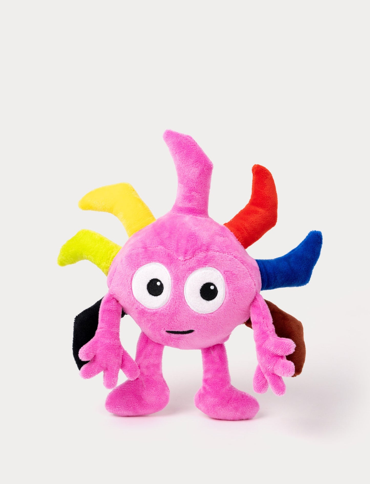 Pink plush toy with large eyes, multiple colorful spikes on its head, and arms with playful fingers.