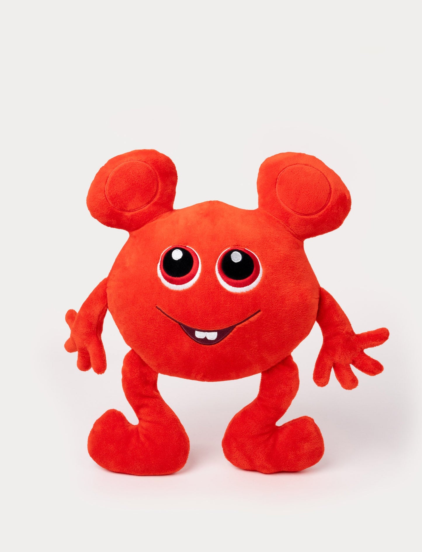 Red plush toy with a round body, large ears, big eyes, and a cheerful embroidered smile with a small tooth.