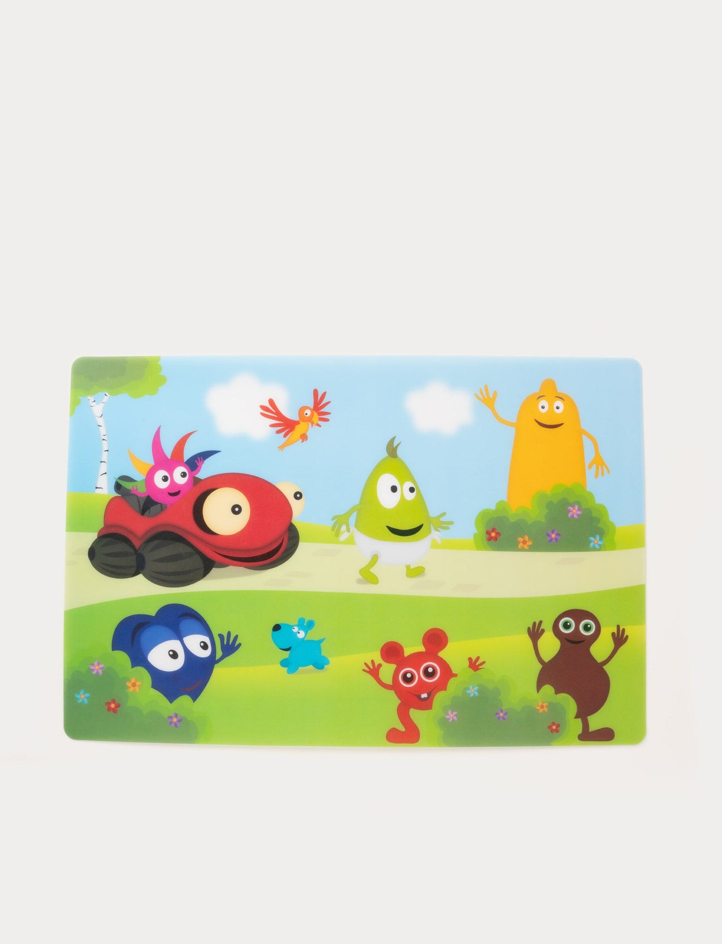 Colorful children's placemat featuring Babblarna characters in a cheerful outdoor scene with trees and clouds.