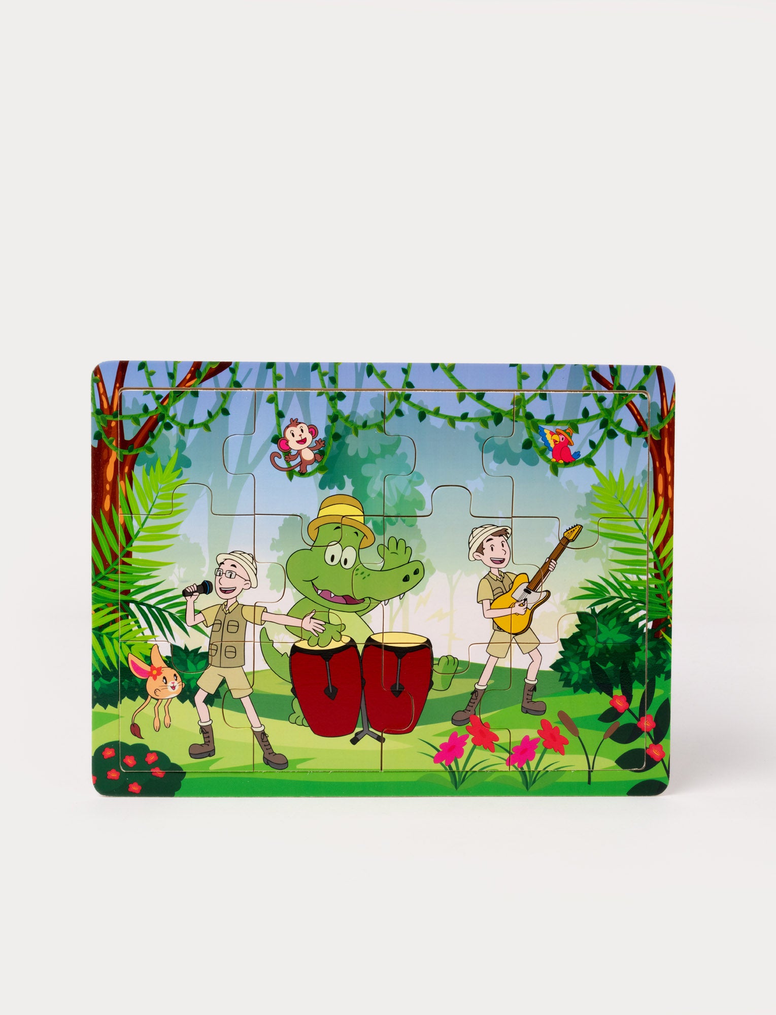 Image of A colorful children's puzzle featuring a jungle scene with a crocodile playing drums, two explorers singing and playing guitar, and animals in the trees.