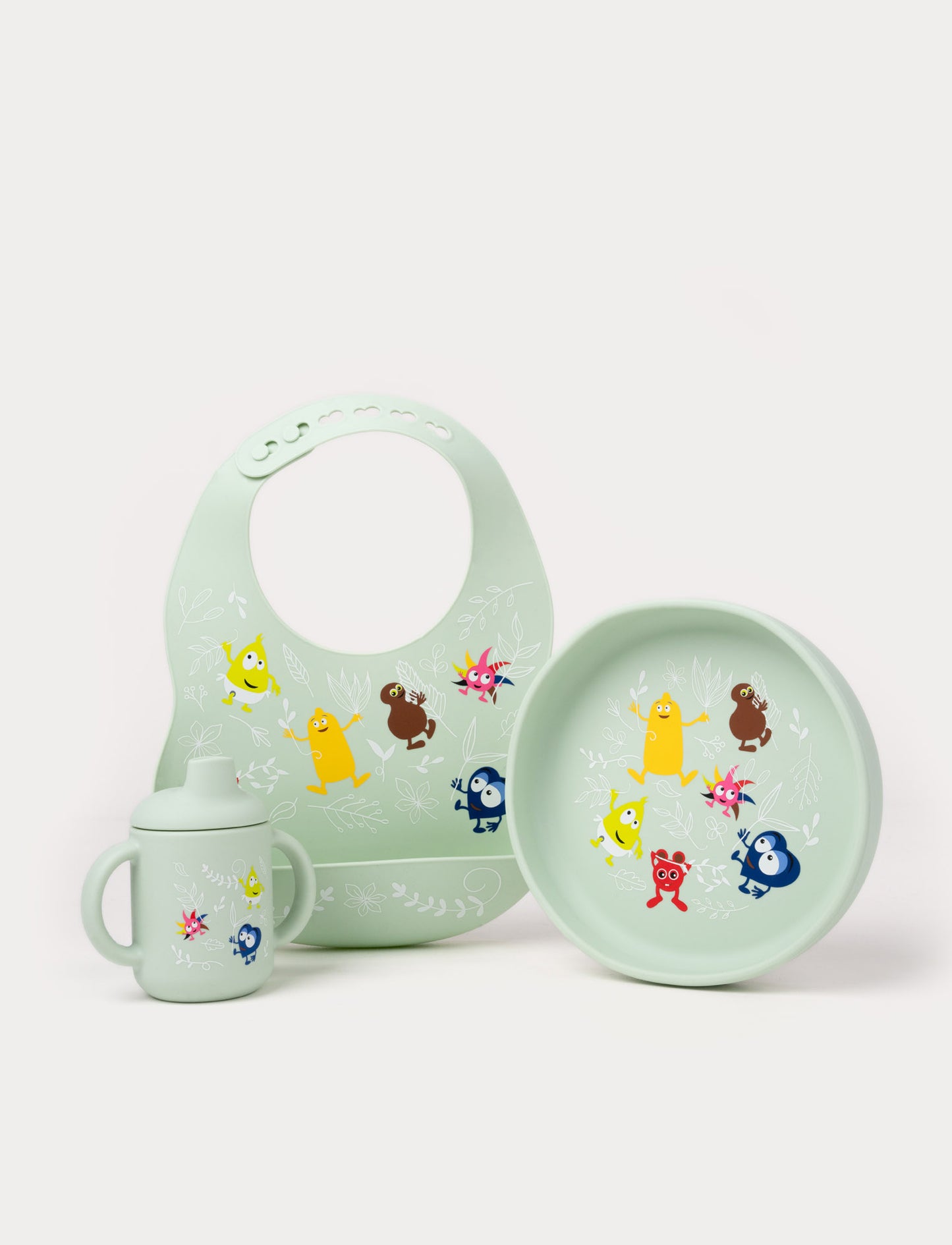 Green silicone baby feeding set with a bib, sippy cup, and plate, decorated with Babblarna characters.