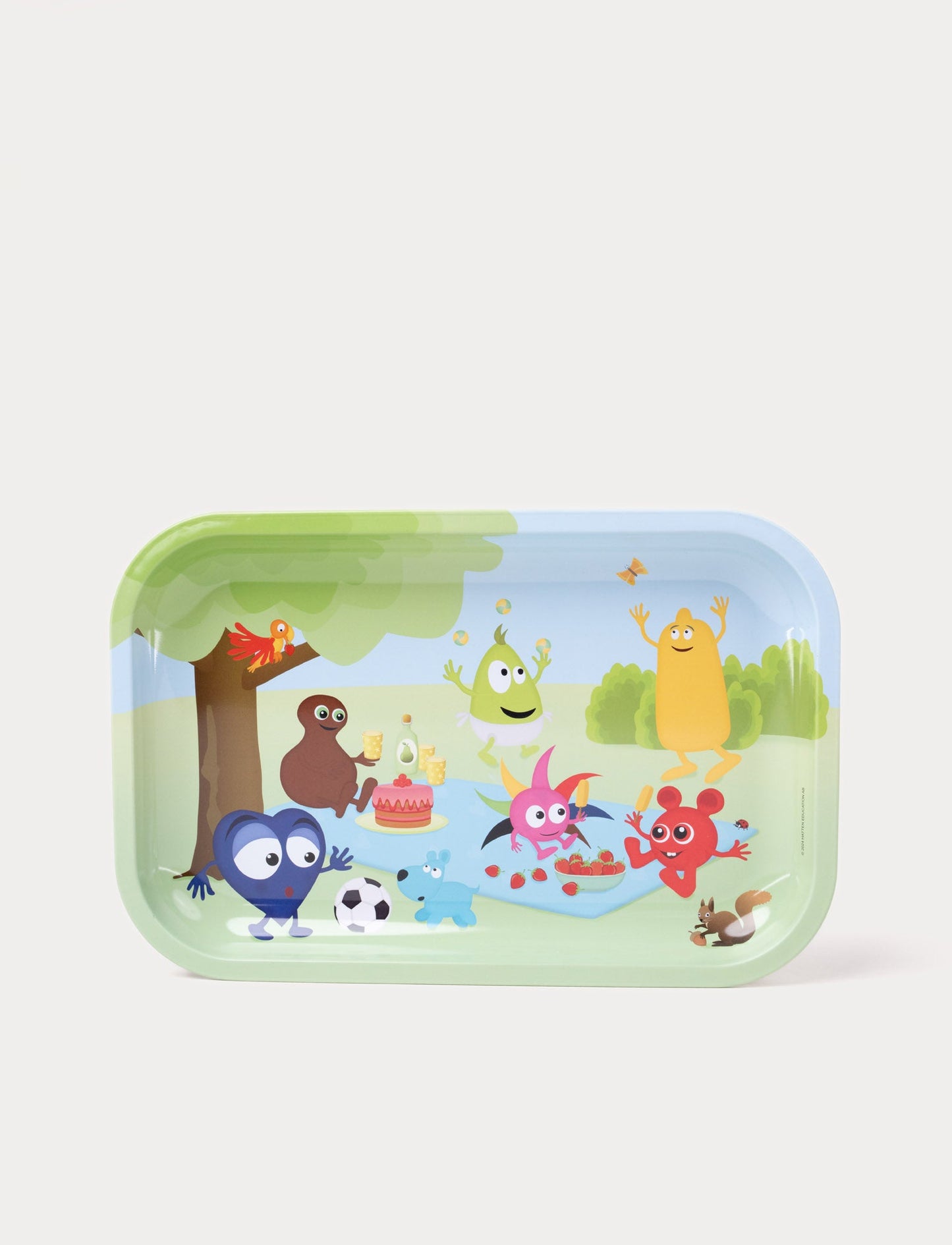 A colorful children's tray featuring Babblarna characters having a picnic in a sunny outdoor setting.