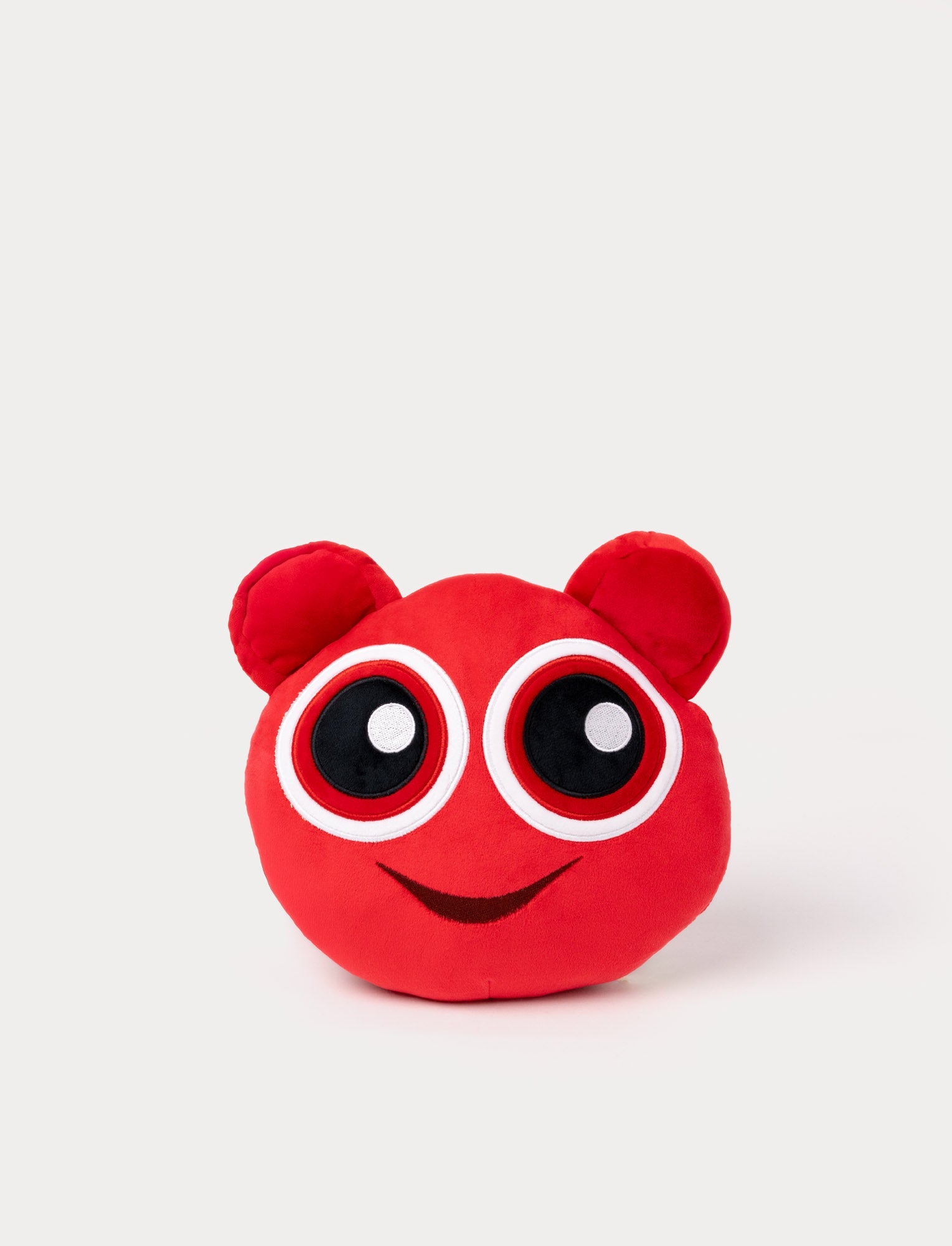 Image of Red plush toy with large round eyes, small ears, and a cheerful embroidered smile.