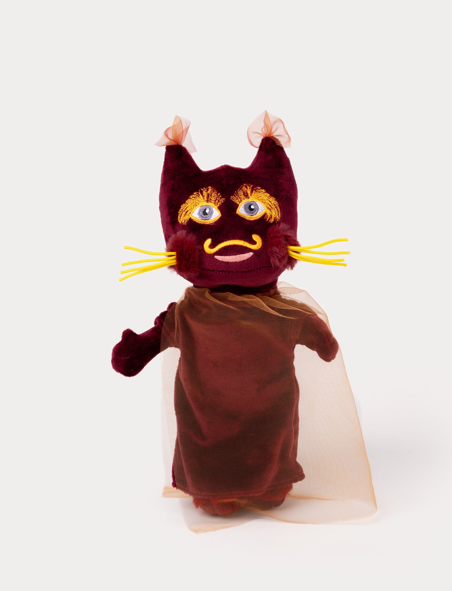 Image of Lavaskuggan in a vibrant red costume with lava-like patterns, featuring a playful expression and energetic pose.