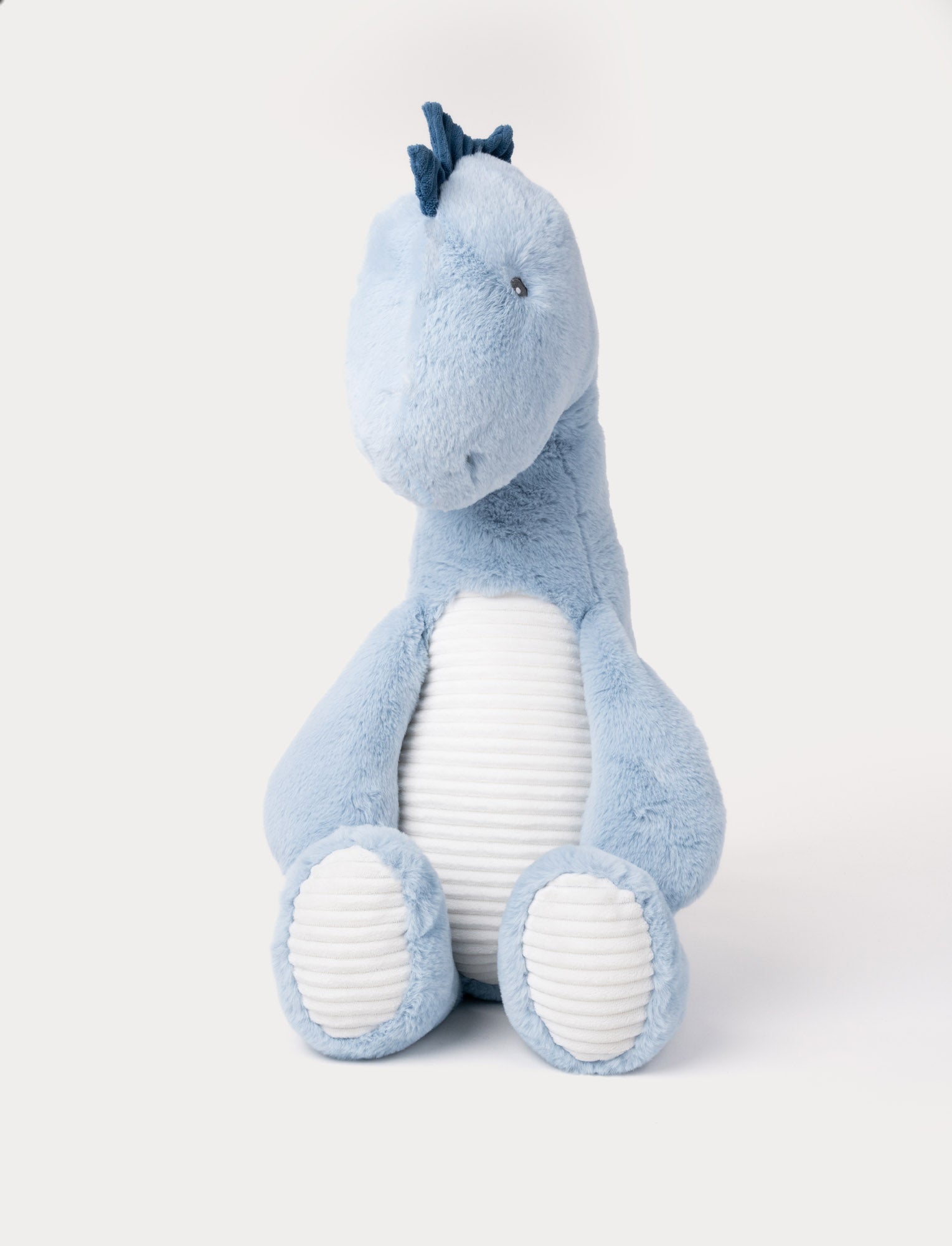 Image of Soft blue plush dinosaur with a white ribbed belly, dark blue spikes, and a friendly expression.
