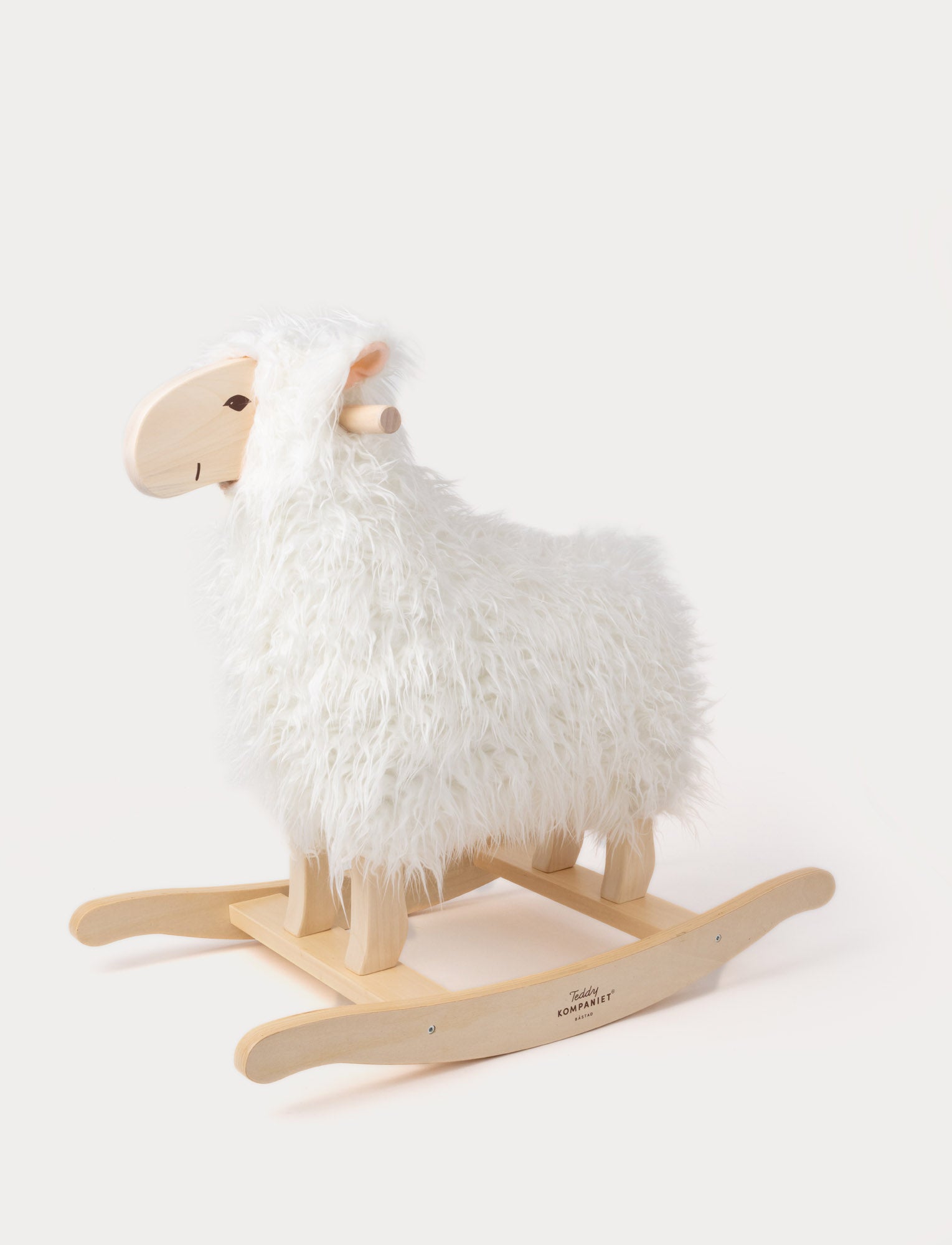 Image of Rocking sheep with fluffy white fur, a wooden face, and a sturdy wooden base.