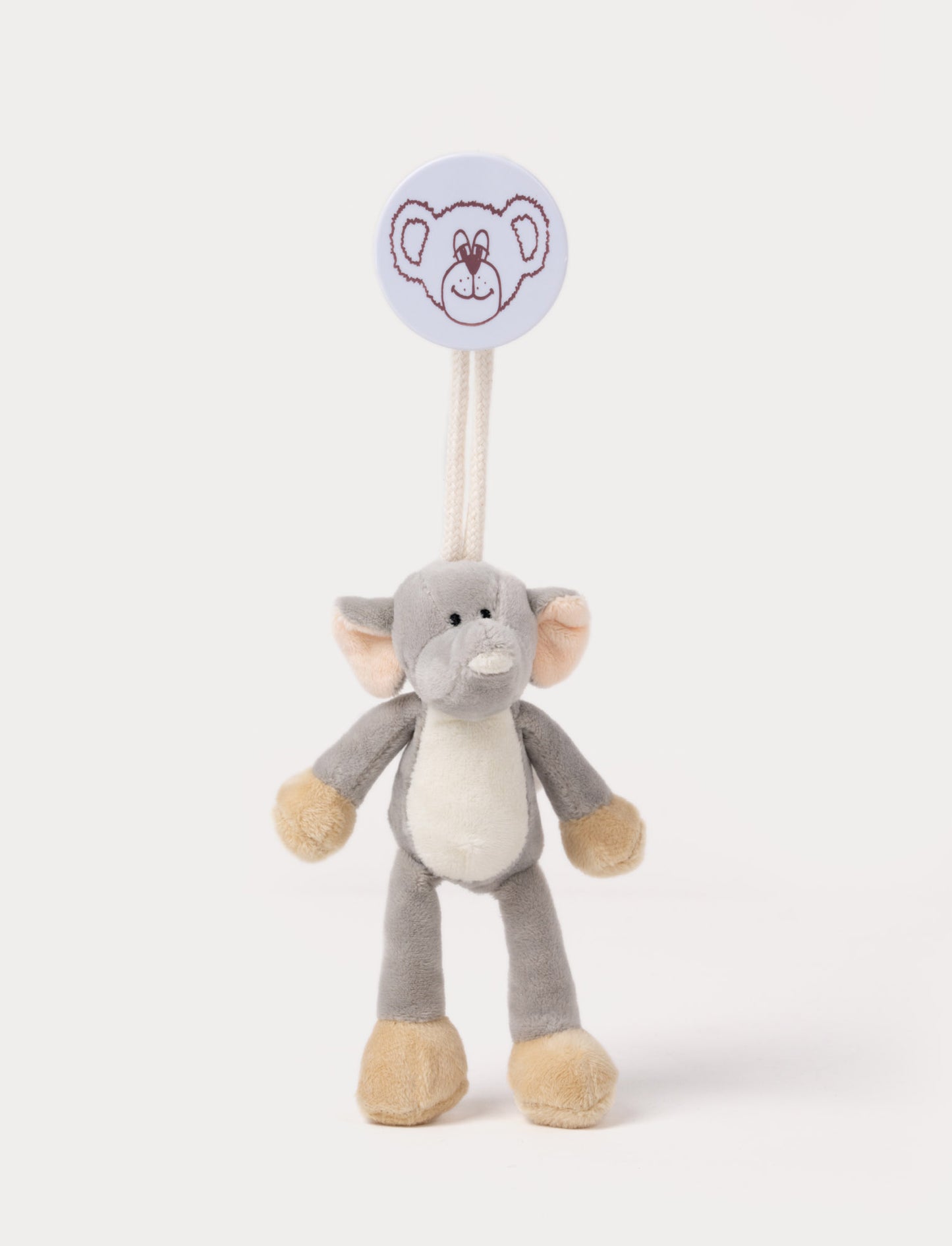 A plush elephant clip toy with large ears, a white belly, beige feet, and a round bear-illustrated clip.