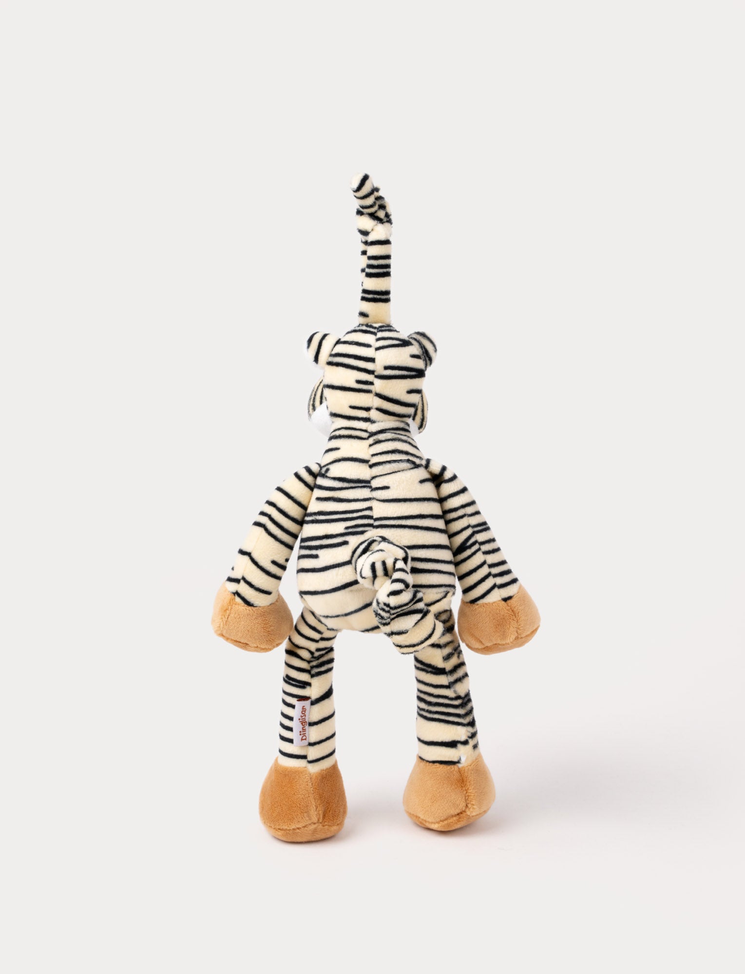 Image of A plush tiger music box with black stripes, a white belly, beige paws, and a fabric loop for hanging