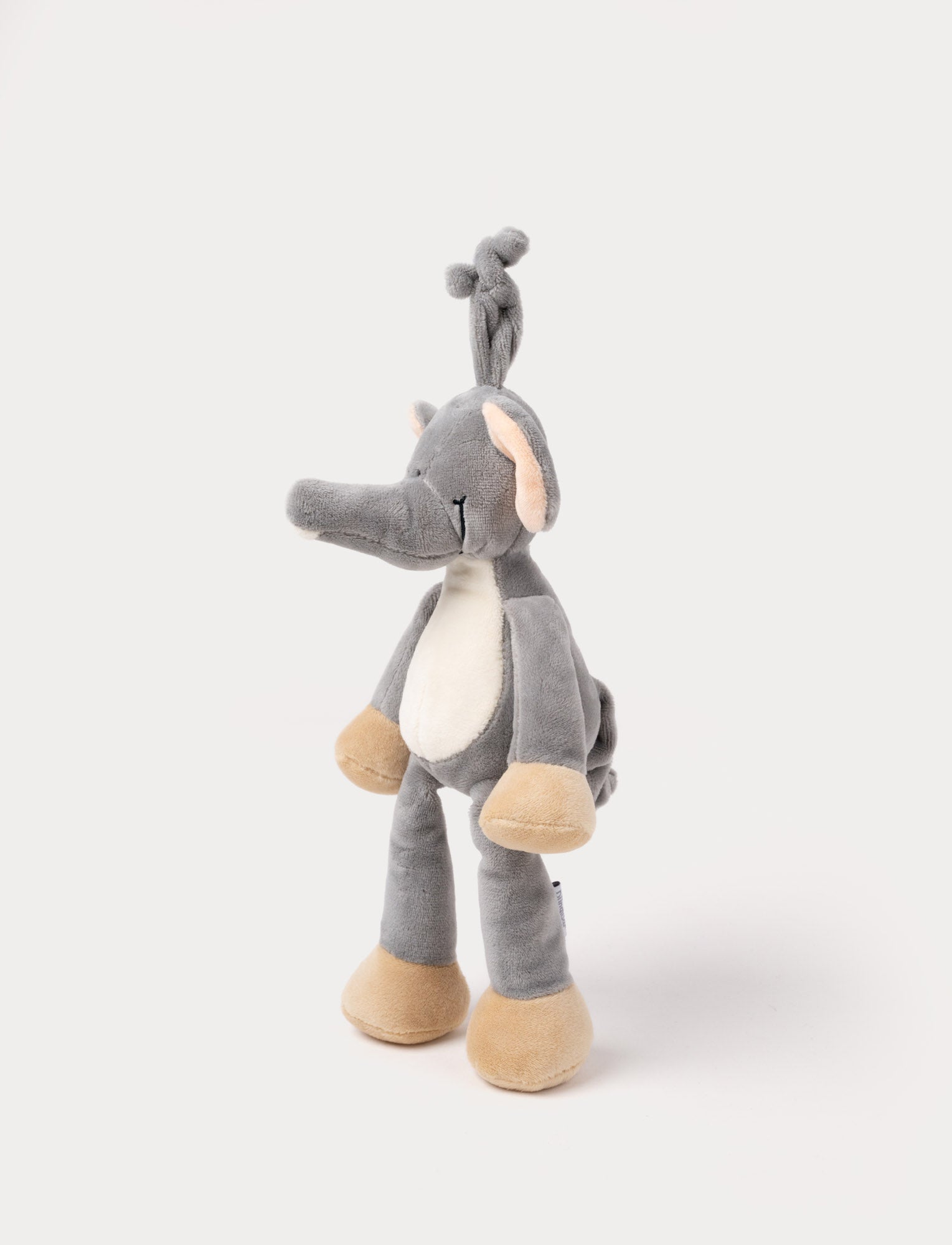 Image of A plush elephant music box with large ears, a white belly, beige feet, and a fabric loop for hanging.