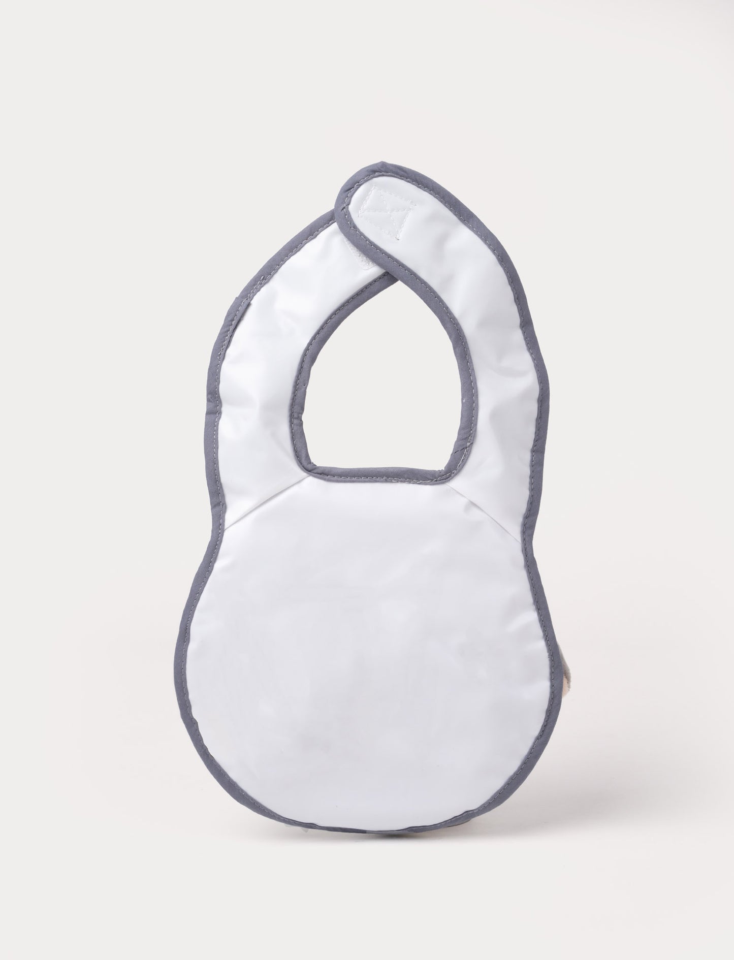 A grey elephant-shaped baby bib with floppy ears, a soft trunk, and a stitched smiling face.