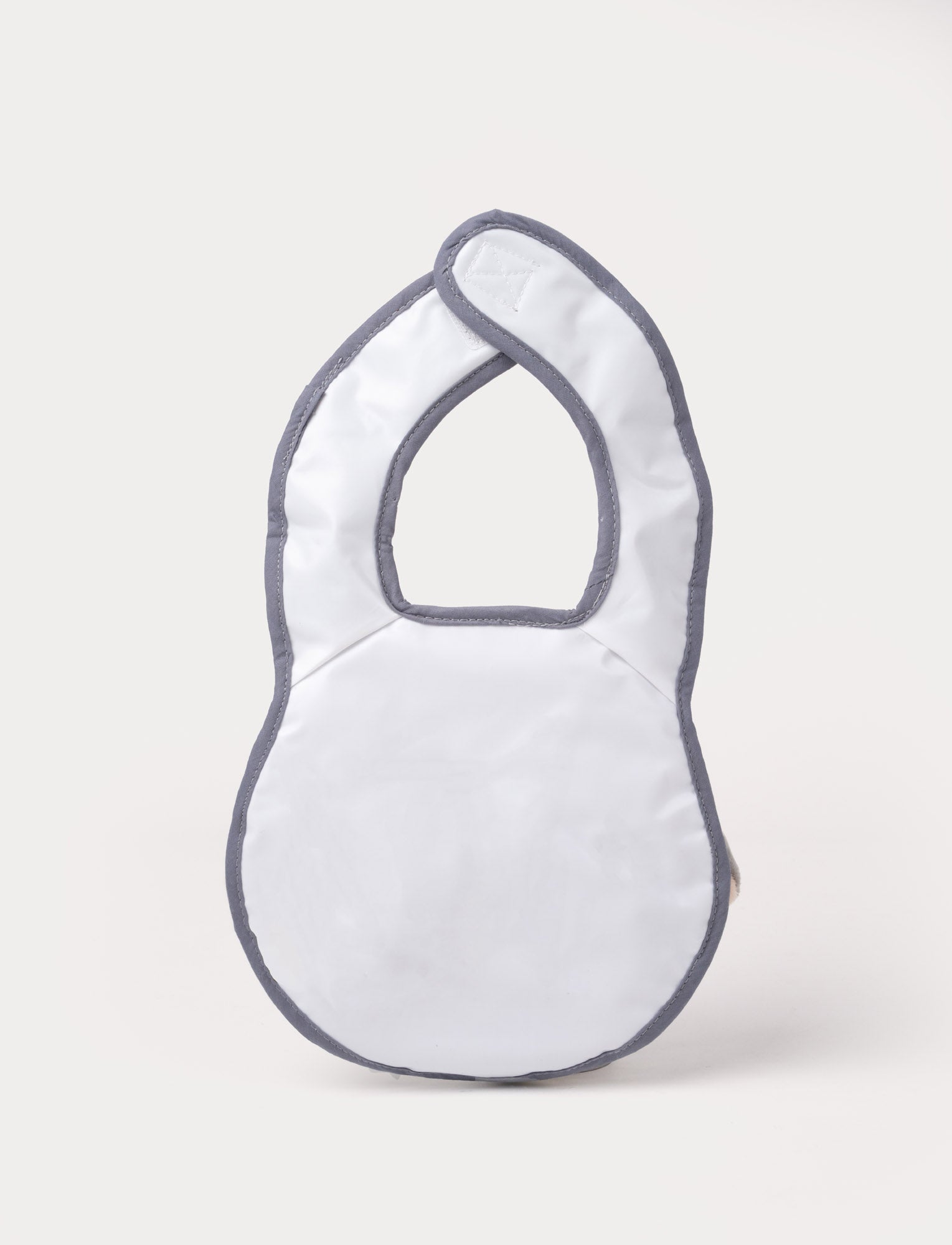 Image of A grey elephant-shaped baby bib with floppy ears, a soft trunk, and a stitched smiling face.