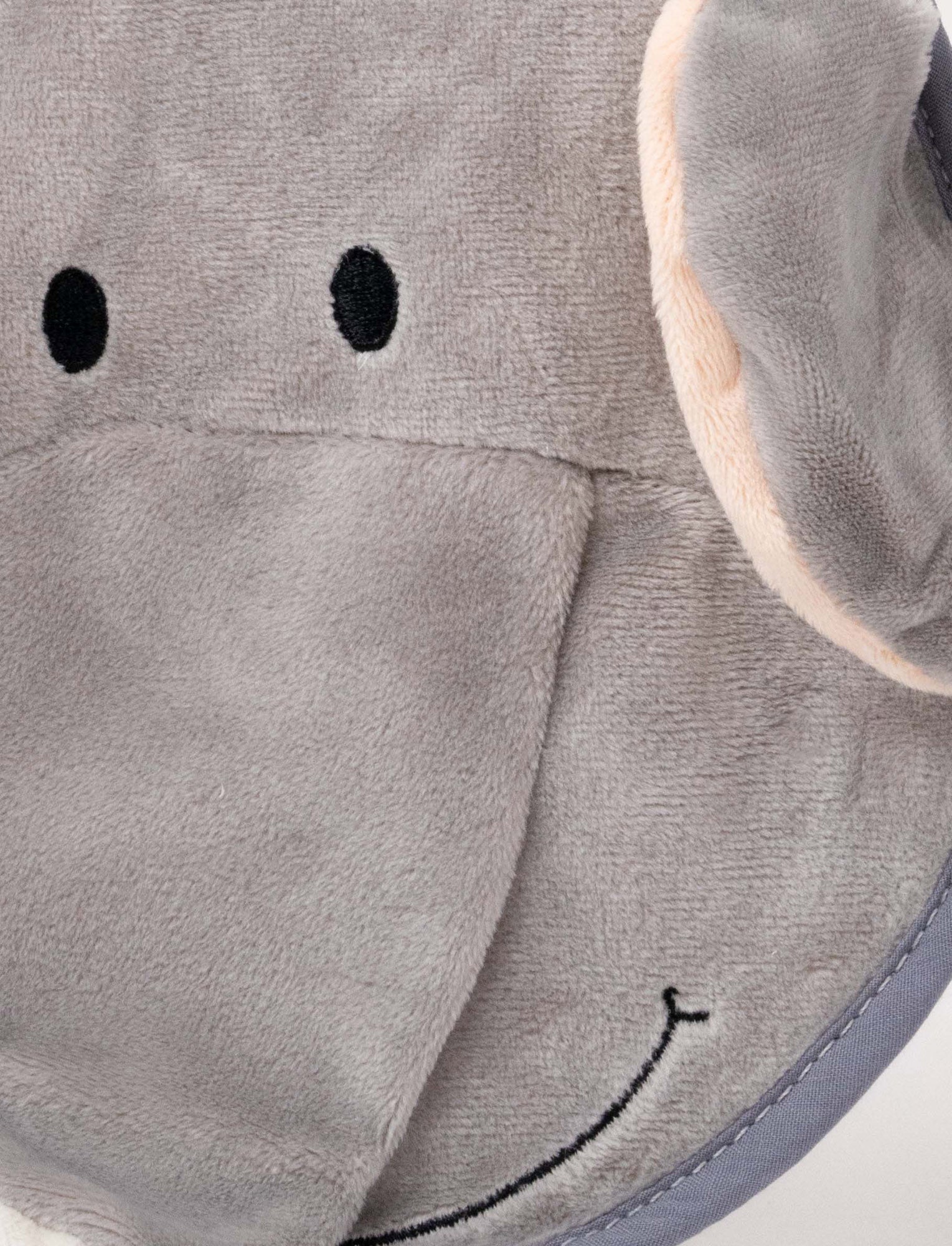 Image of A grey elephant-shaped baby bib with floppy ears, a soft trunk, and a stitched smiling face.