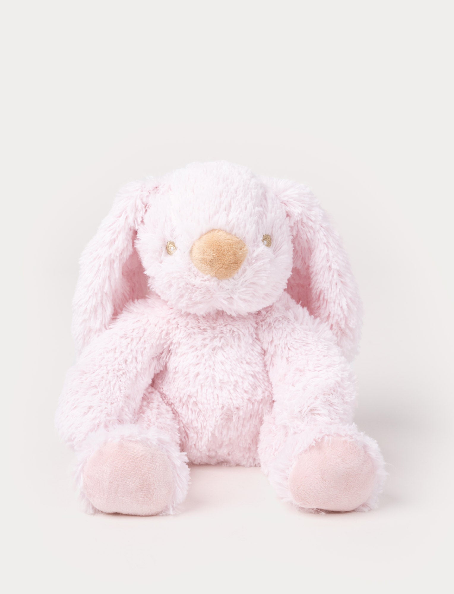 Image of A soft pink plush bunny with floppy ears, a beige nose, and golden-stitched eyes.