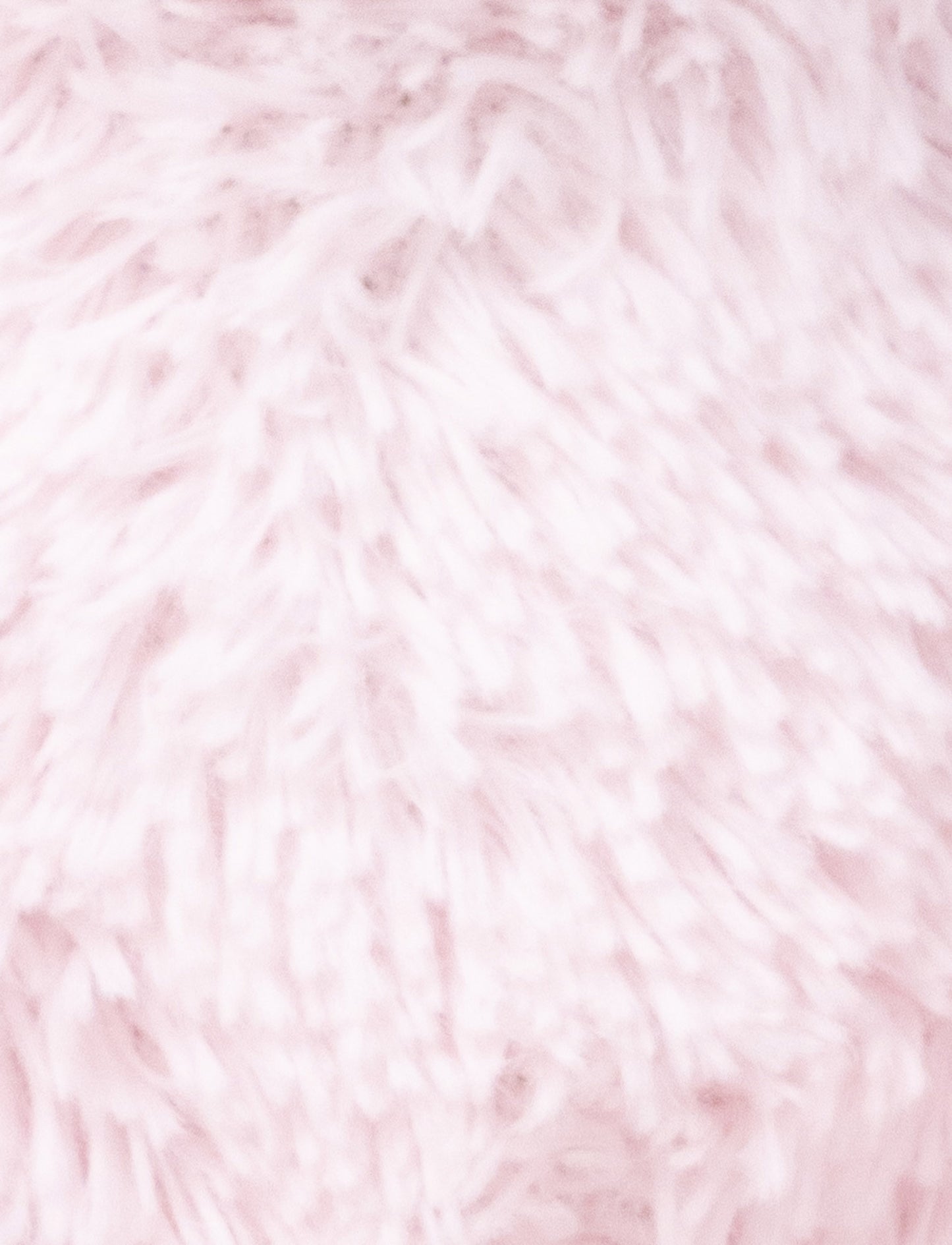 A soft pink plush bunny with floppy ears, a beige nose, and golden-stitched eyes