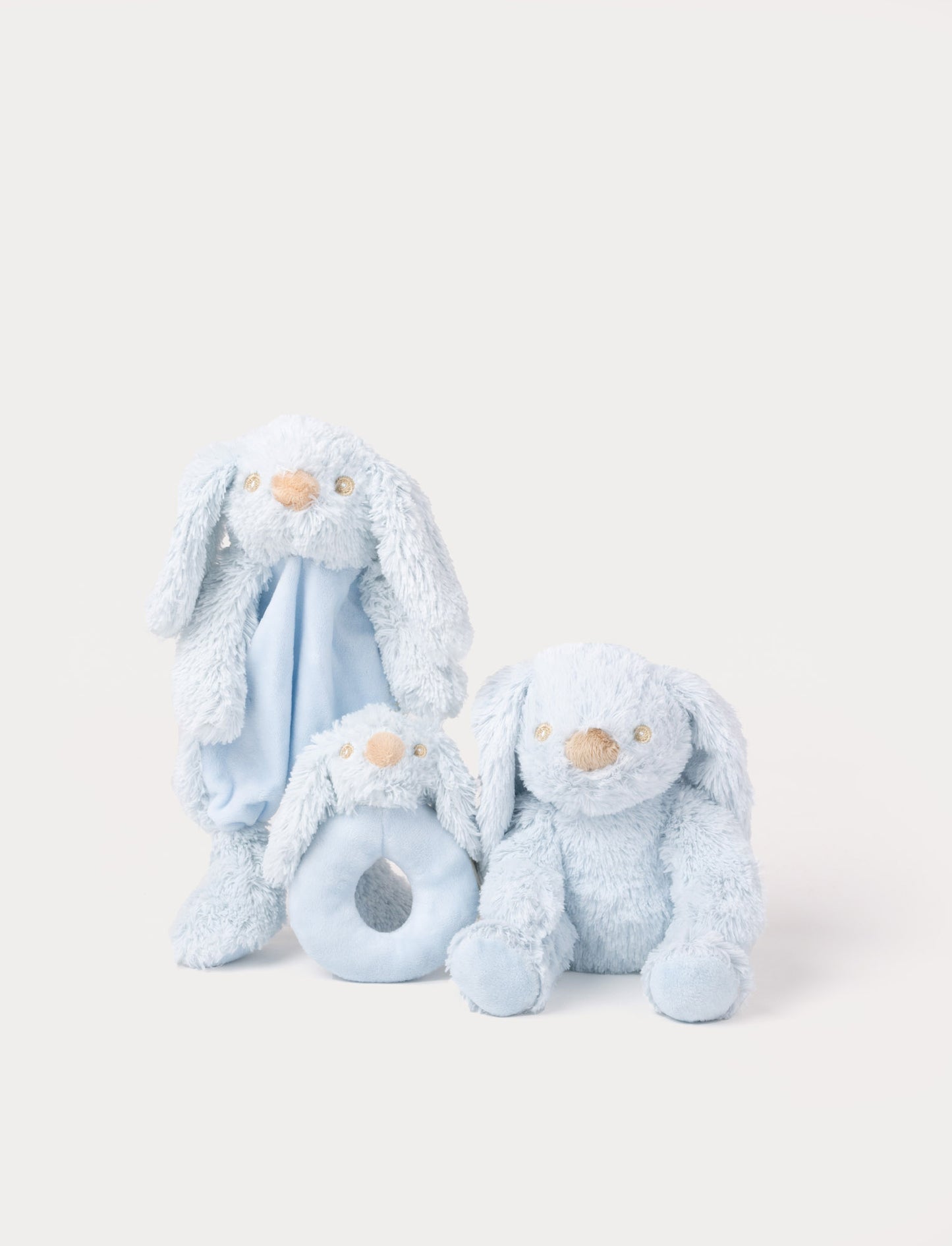 Set of three light blue bunny plush toys, including a comfort blanket, a rattle, and a soft stuffed rabbit.