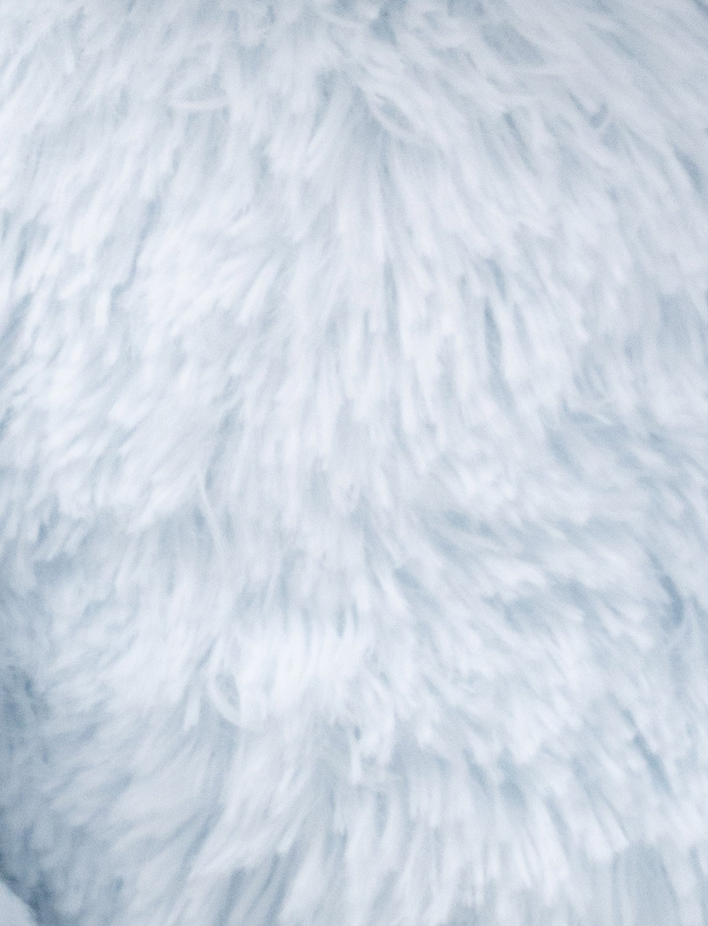 A soft blue plush bunny with floppy ears, a beige nose, and golden-stitched eyes.