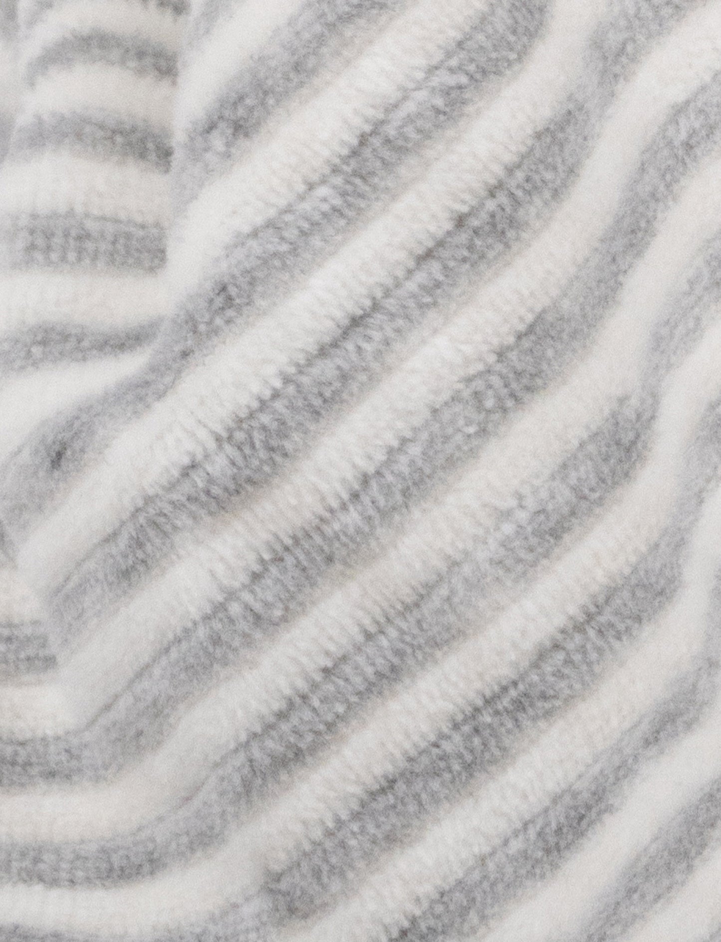 A grey and white striped plush bunny comforter with floppy ears and knotted fabric ends.