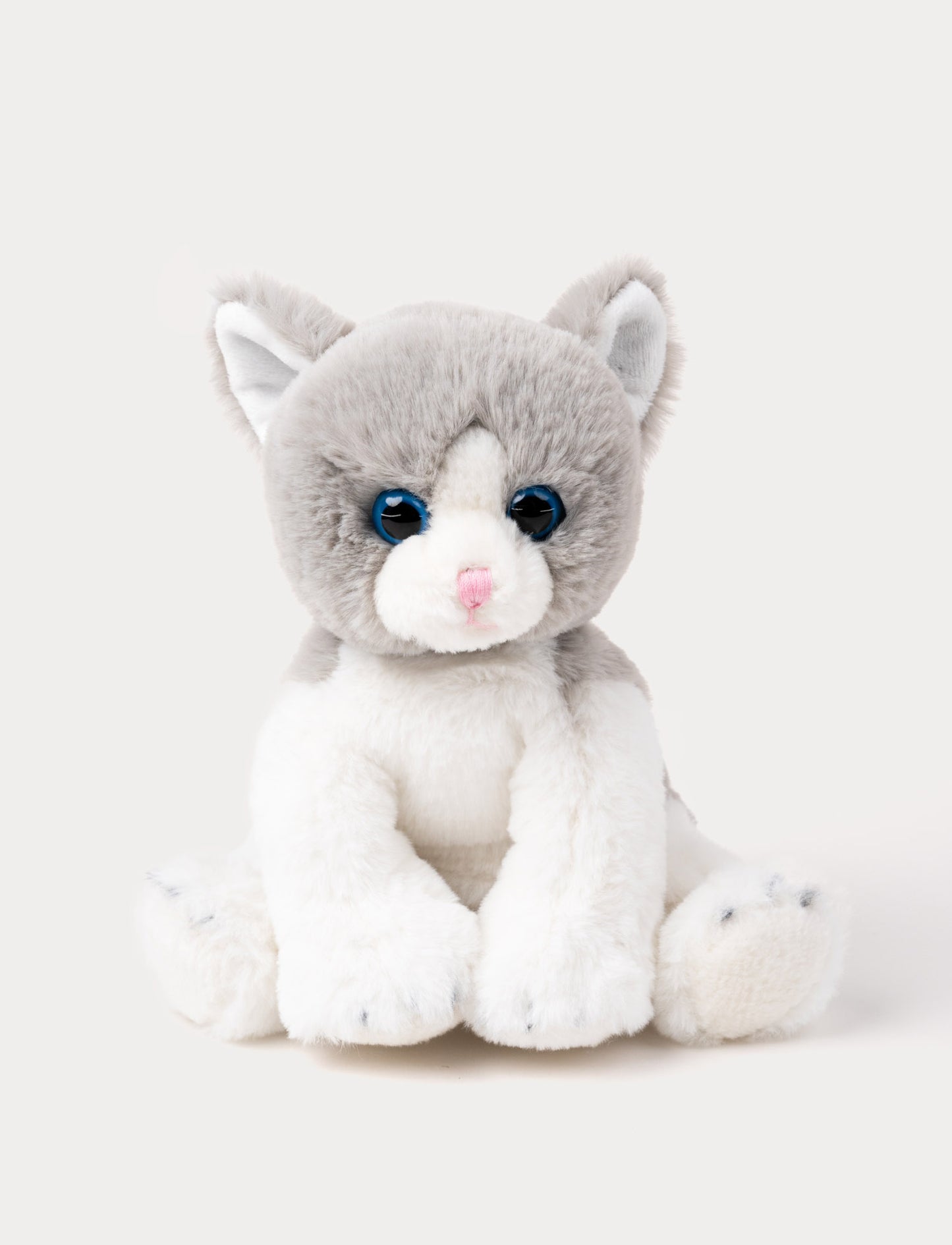 Soft grey and white kitten plush with blue eyes, a pink nose, and white paws.