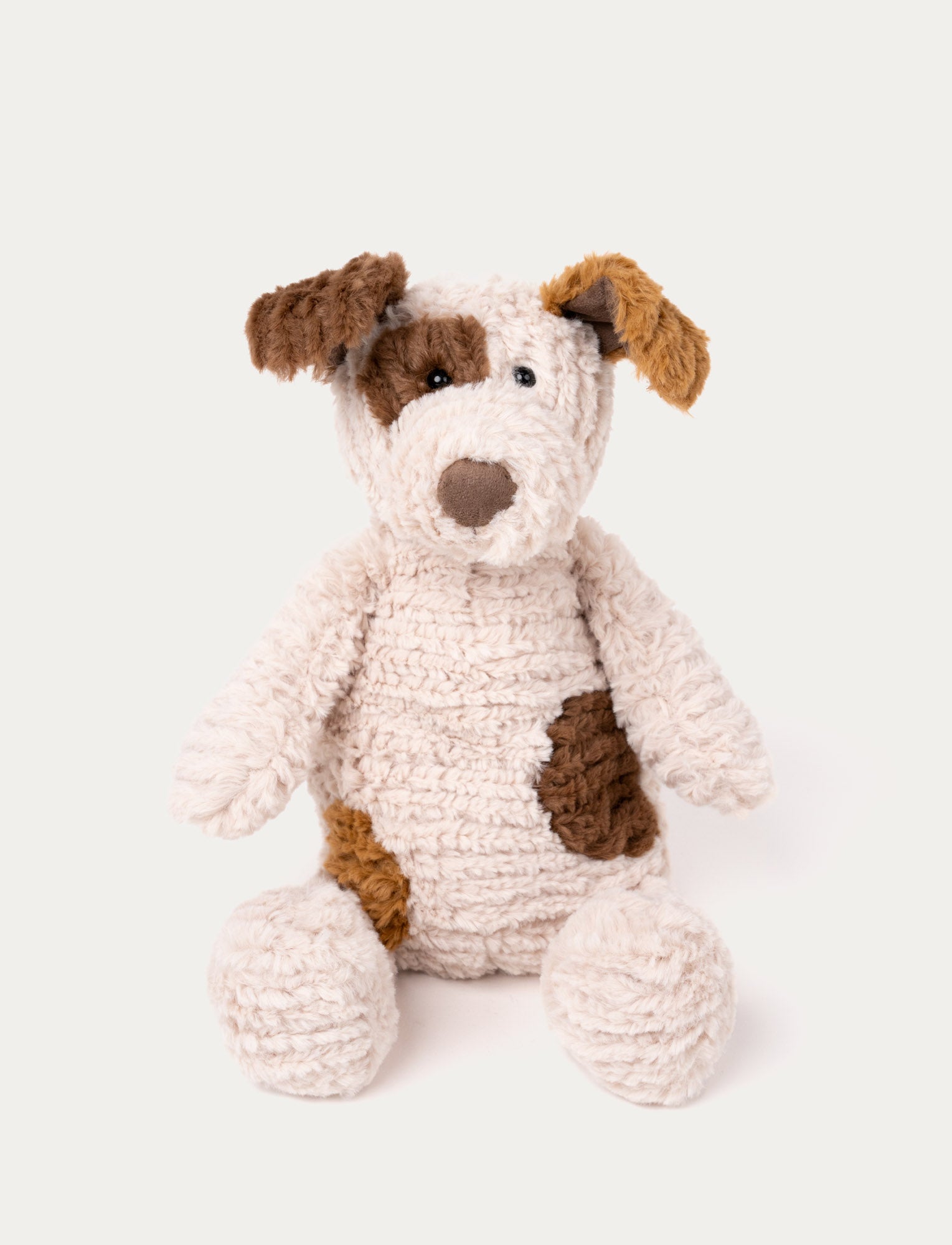 Image of Soft, cream-colored plush dog with a textured, knitted look, brown patches, floppy ears, and a stitched brown nose.