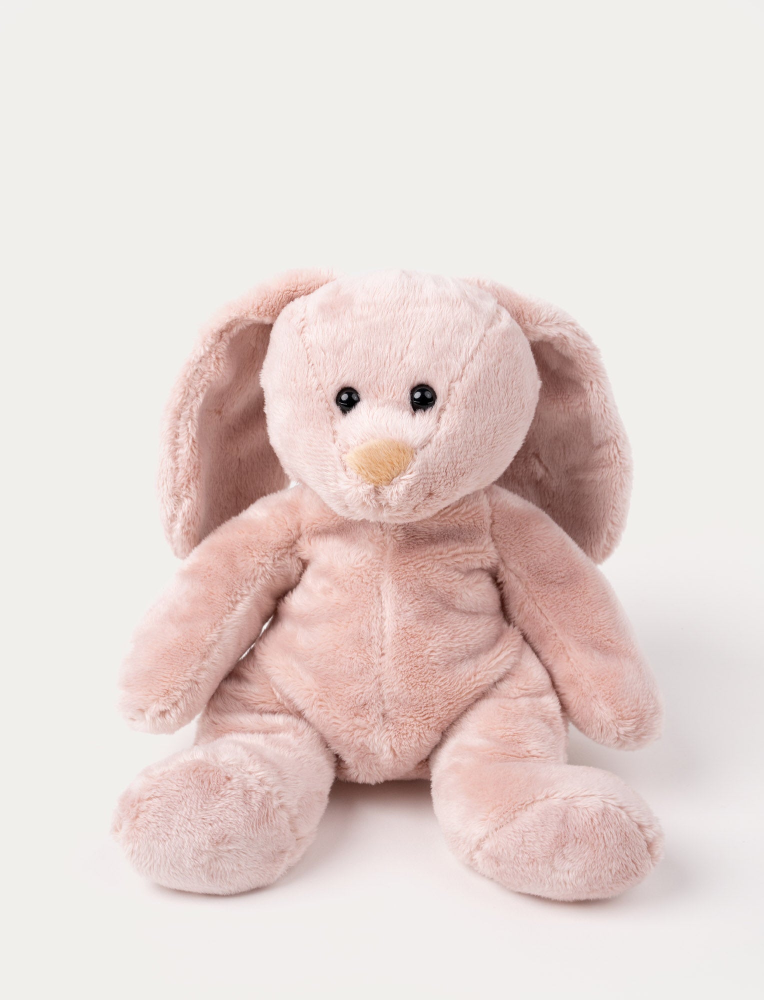 Image of Soft pink bunny plush with long floppy ears, a beige nose, and shiny black eyes.
