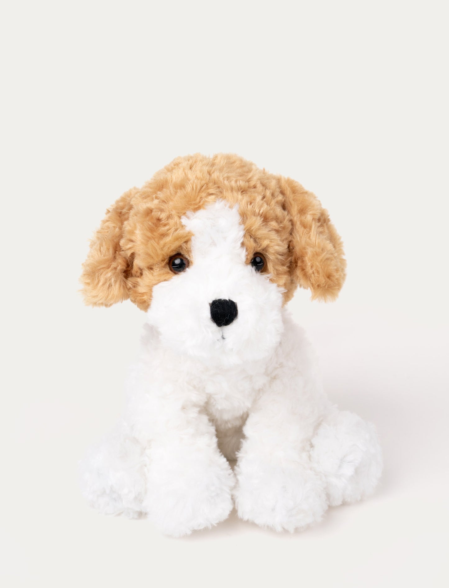 Soft plush dog with curly white fur, light brown floppy ears, black eyes, and a stitched black nose.