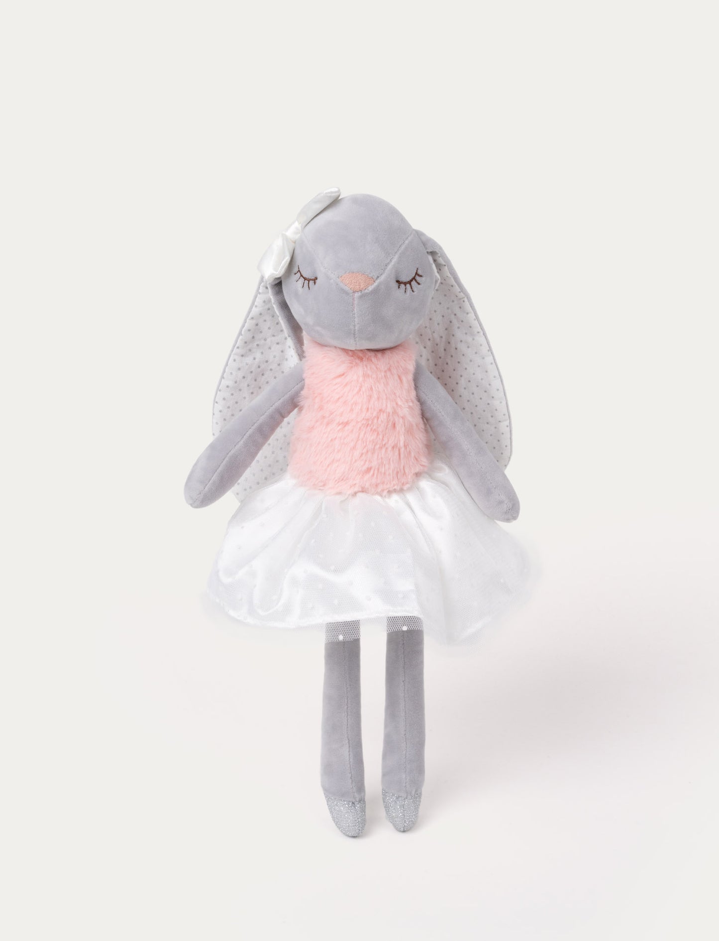 Soft, plush bunny doll with grey fur, long floppy ears, a pink furry chest, a white skirt, and a satin bow on one ear.