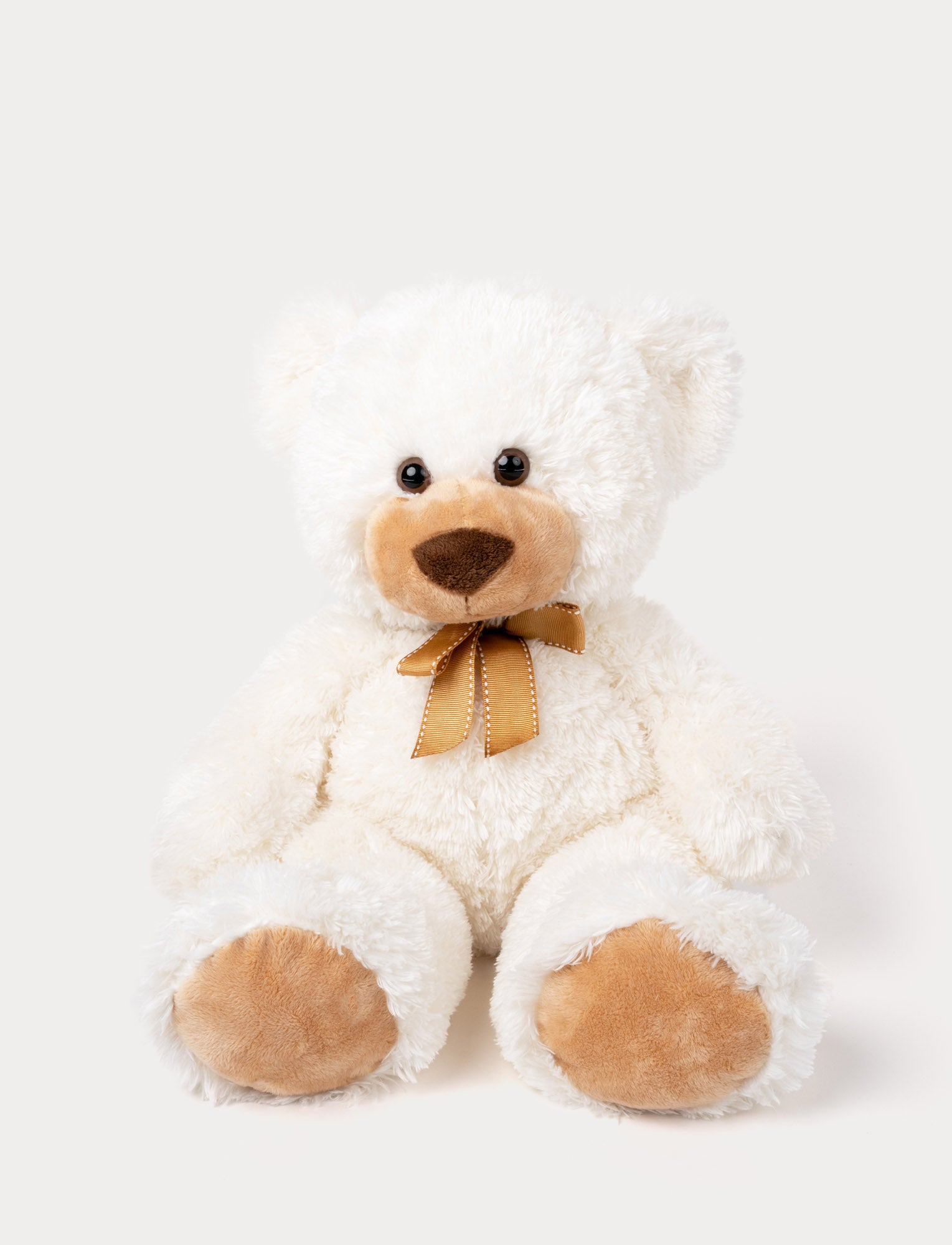 Image of Soft, plush teddy bear with fluffy white fur, brown paw pads, a stitched nose, and a golden ribbon around its neck.