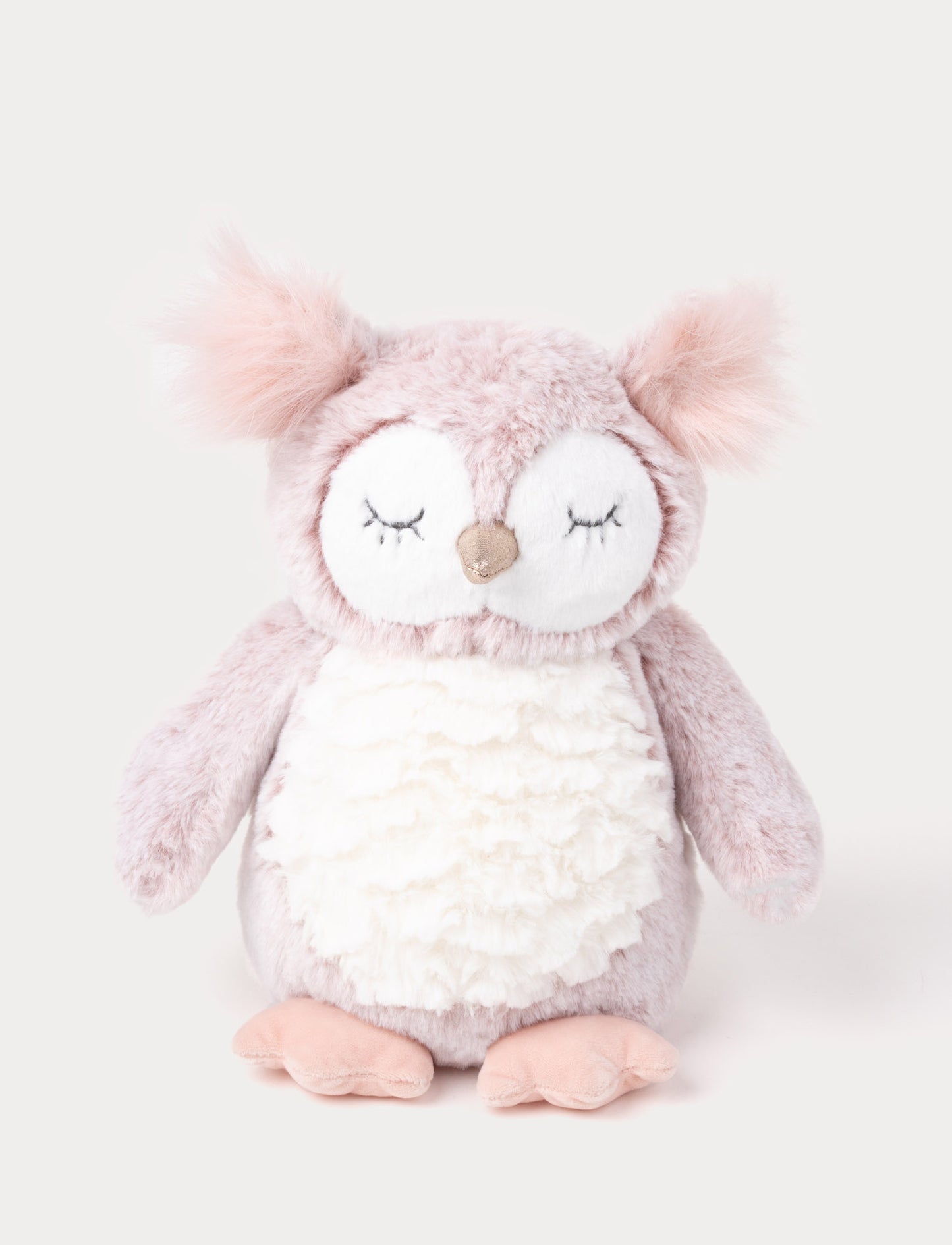 An owl with cozy pink-mottled fur, a white belly, long tufts, and a shimmering silver beak.