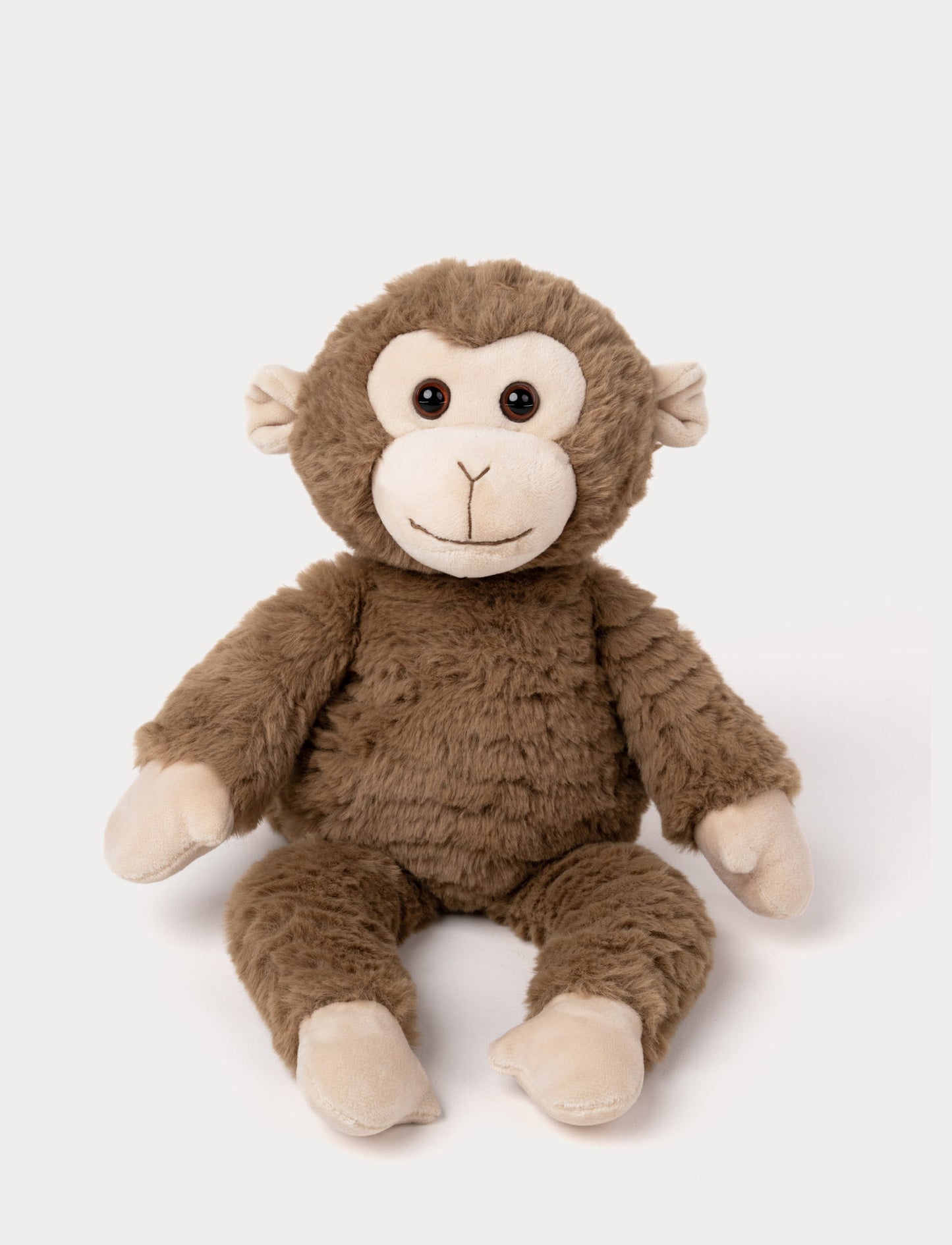 Soft plush monkey with brown fur, a beige face and paws, black bead eyes, and a stitched smile.