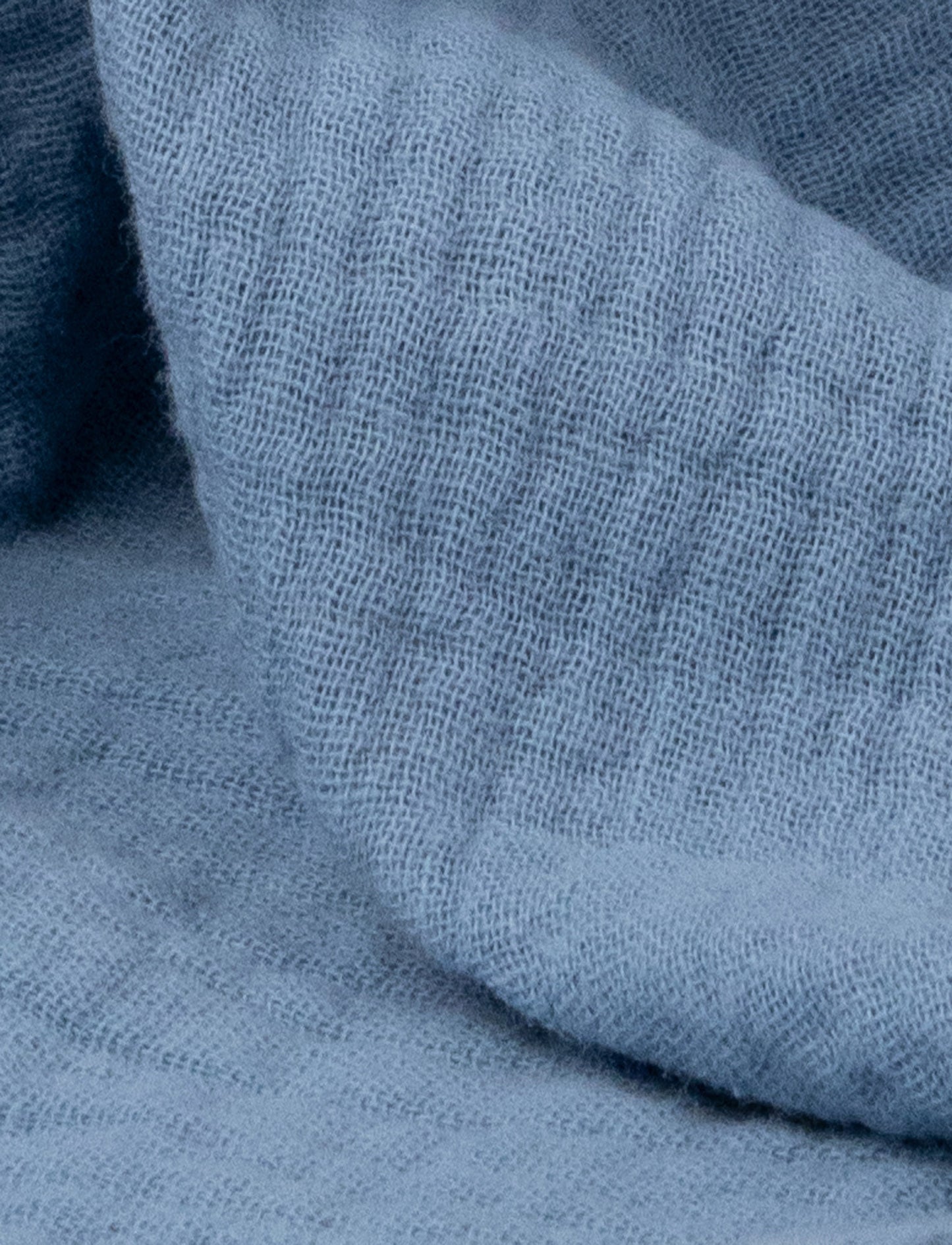 A soft blue baby blanket with a plush bunny,white details and cotton fabric