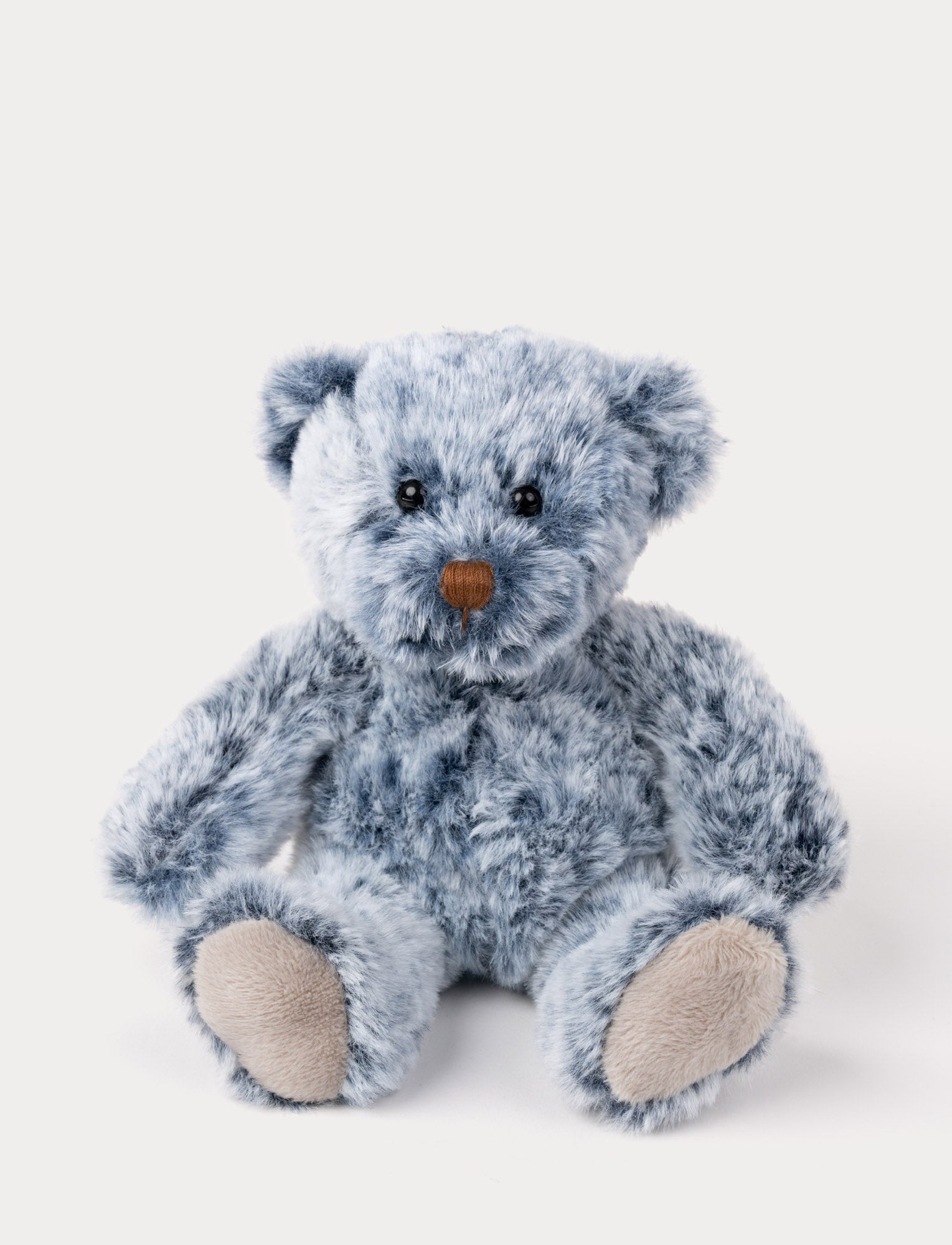 Image of A small teddy bear with a soft plush coat in beautiful blue tones and unique marbled design.