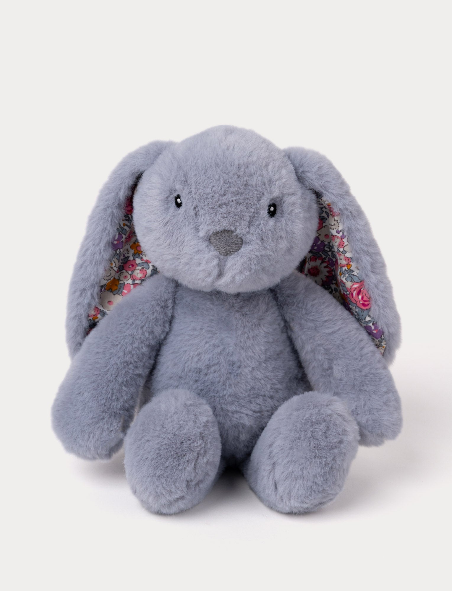 Image of Soft lilac plush bunny with floral-patterned inner ears, embroidered eyes, and a stitched nose.