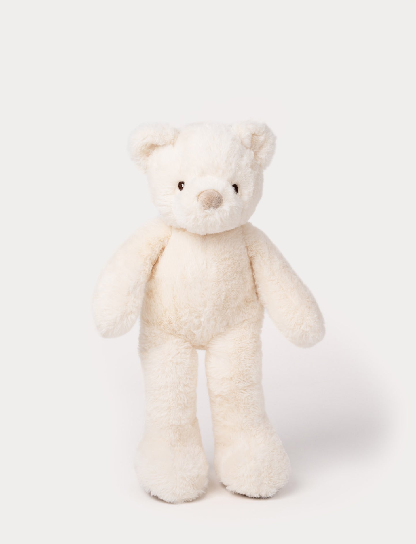 White plush teddy bear with long legs, round ears, and a soft beige nose.