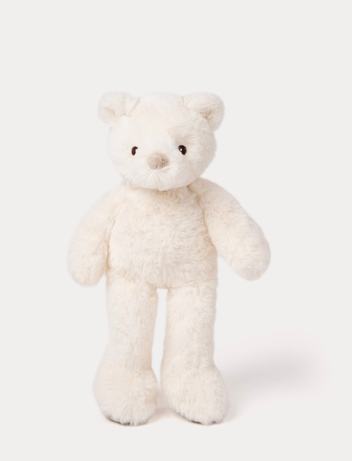 White plush teddy bear with long legs, round ears, and a soft beige nose.
