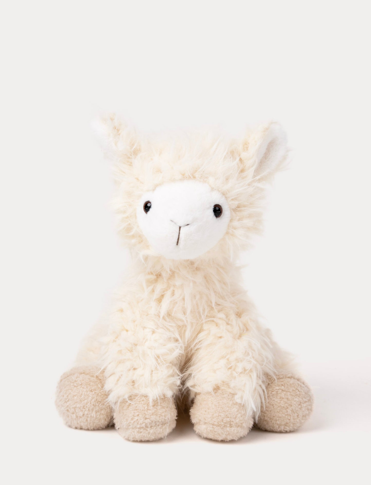 Soft plush llama with fluffy cream-colored fur, a white face, black eyes, and beige hooves.