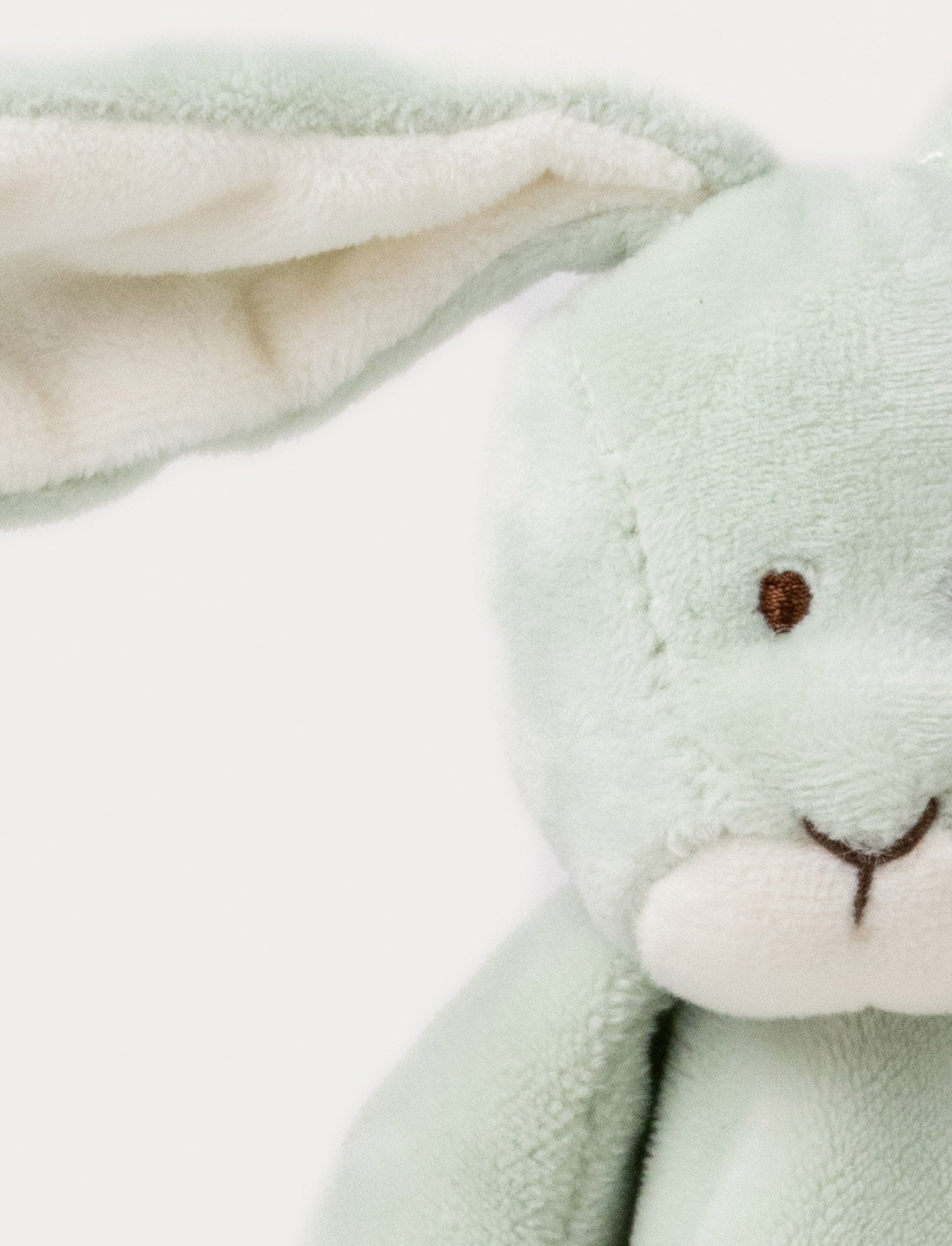 Image of Soft baby blanket with a plush green bunny head, long floppy ears, and white-trimmed edges.