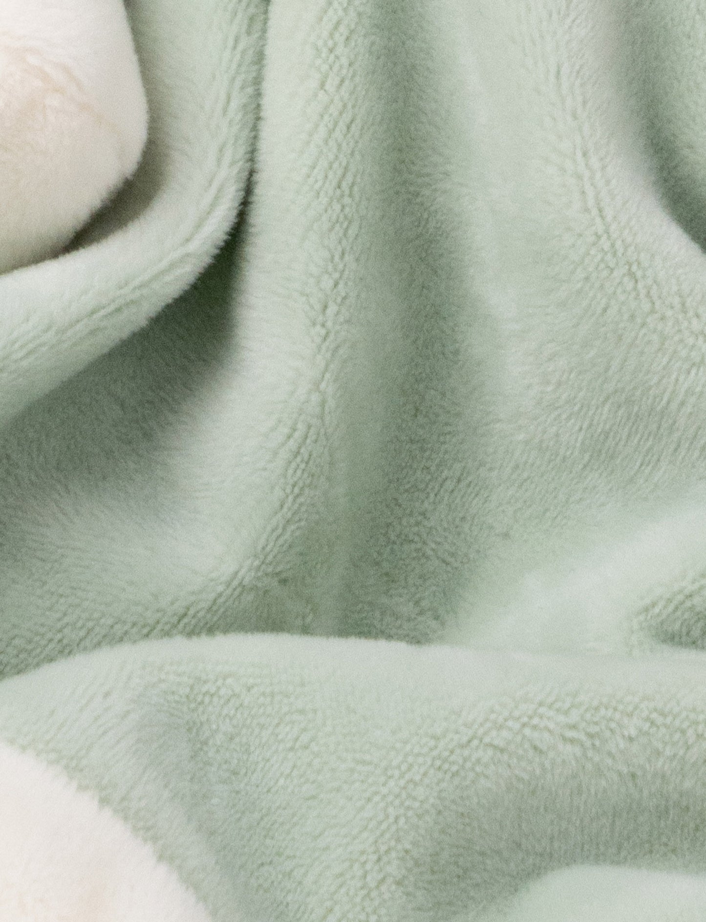 Soft baby blanket with a plush green bunny head, long floppy ears, and white-trimmed edges.
