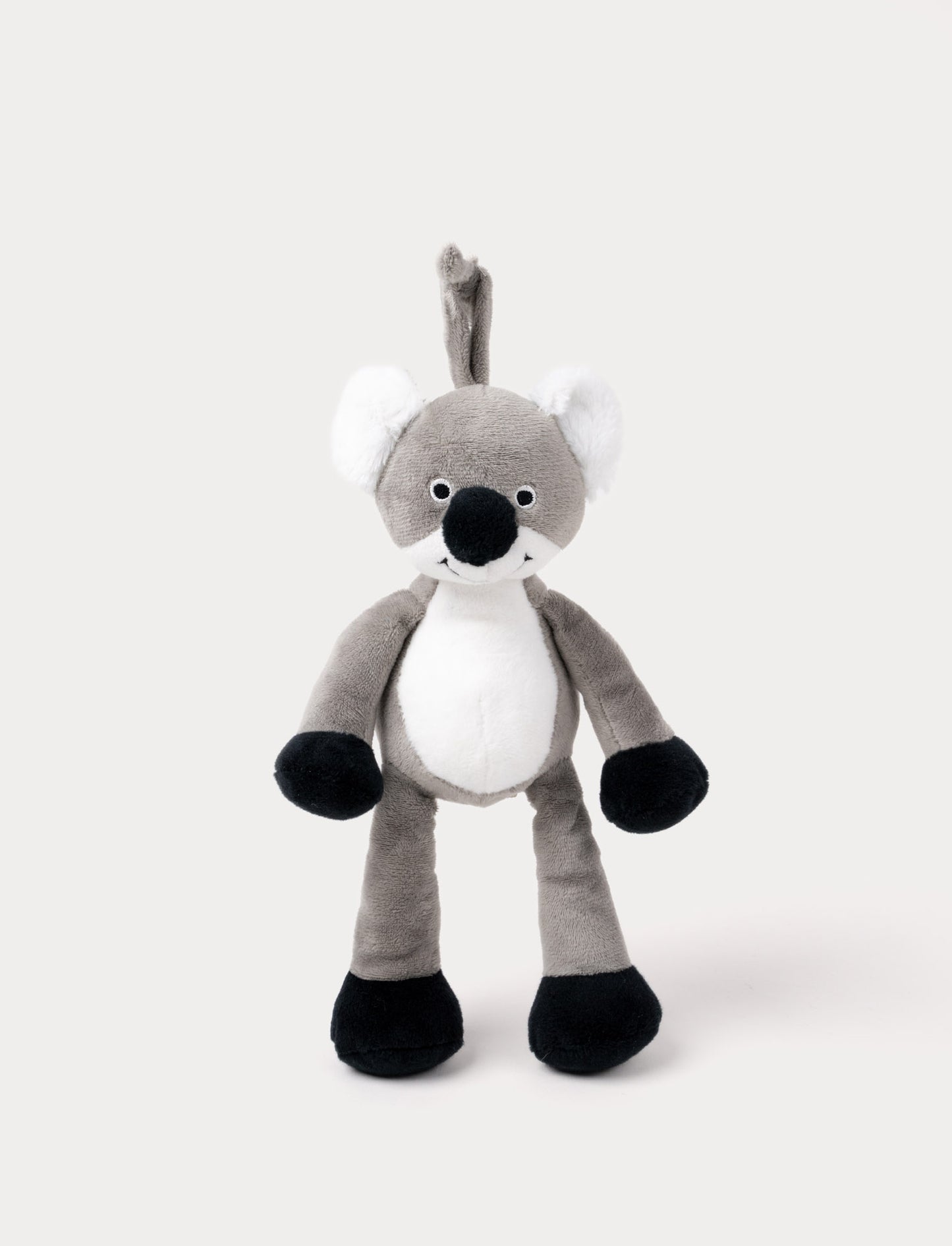 A plush koala music box with a white belly, black paws, and a hanging loop