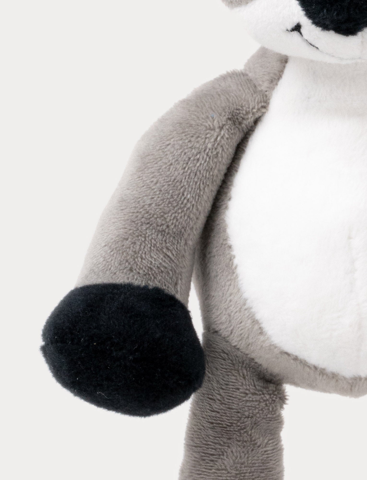 Image of A plush koala music box with a white belly, black paws, and a hanging loop