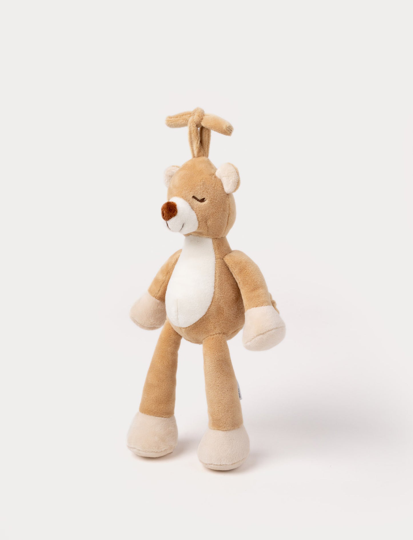 A plush brown teddy bear music box with a white belly, closed eyes, and a hanging loop.