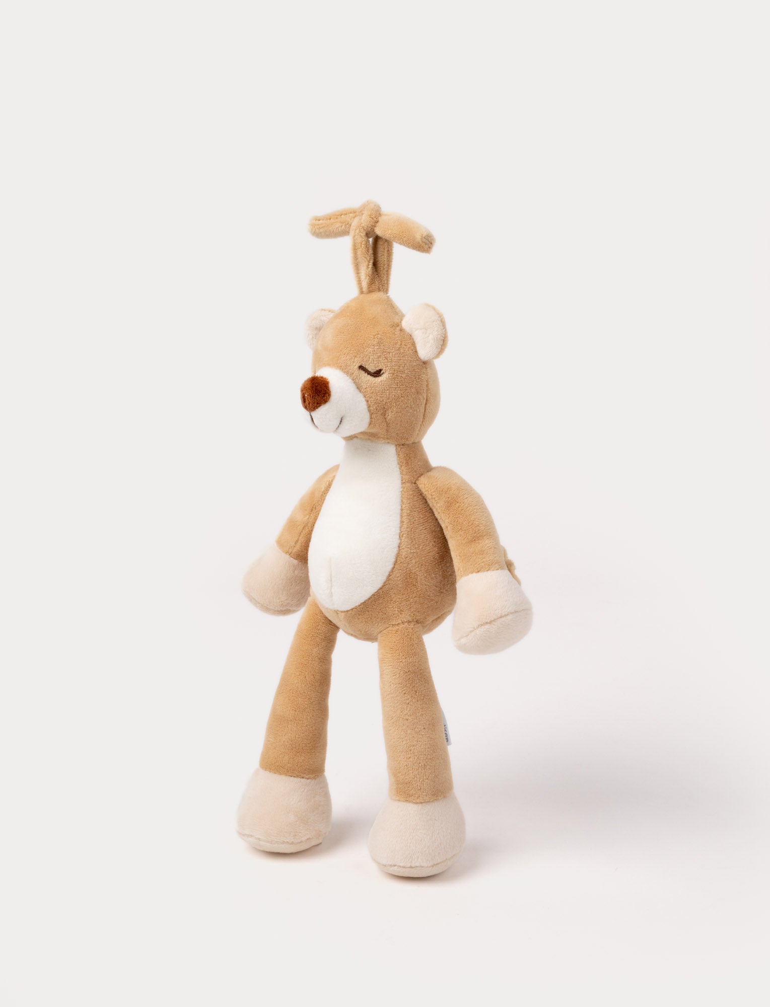 Image of A plush brown teddy bear music box with a white belly, closed eyes, and a hanging loop.