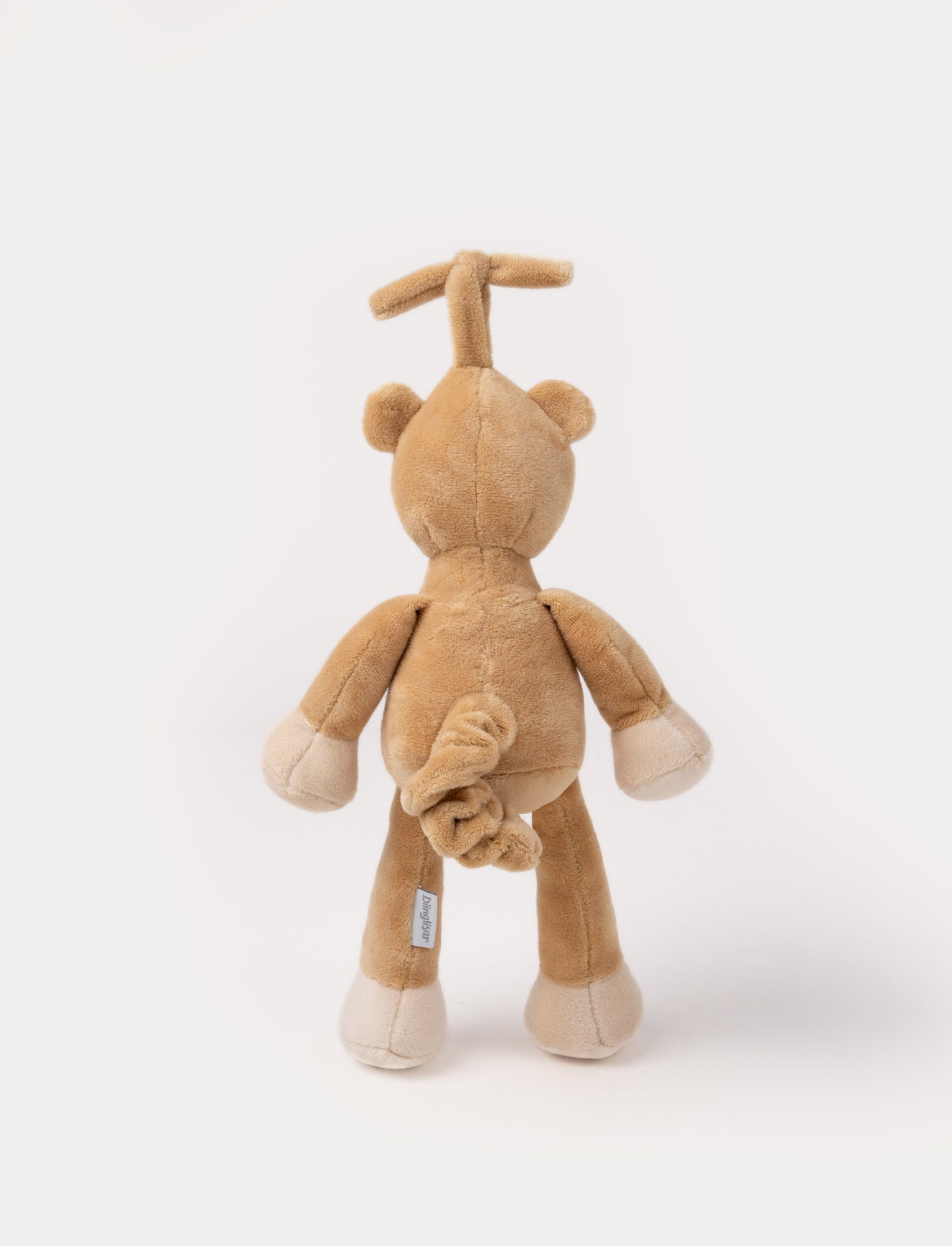 Image of A plush brown teddy bear music box with a white belly, closed eyes, and a hanging loop.