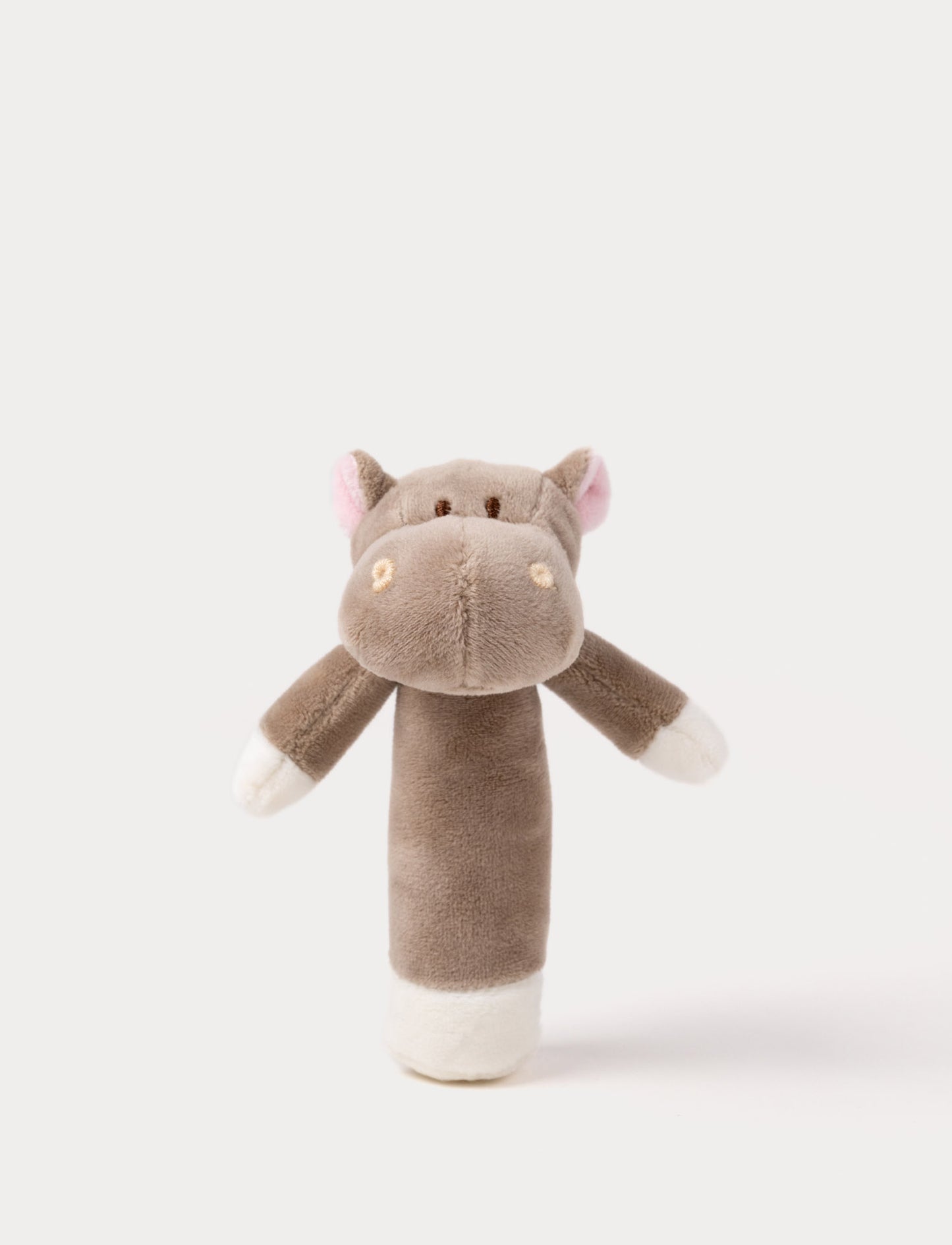Soft plush hippo rattle with a brown body, embroidered eyes, small pink ears, and white accents on the hands and base.