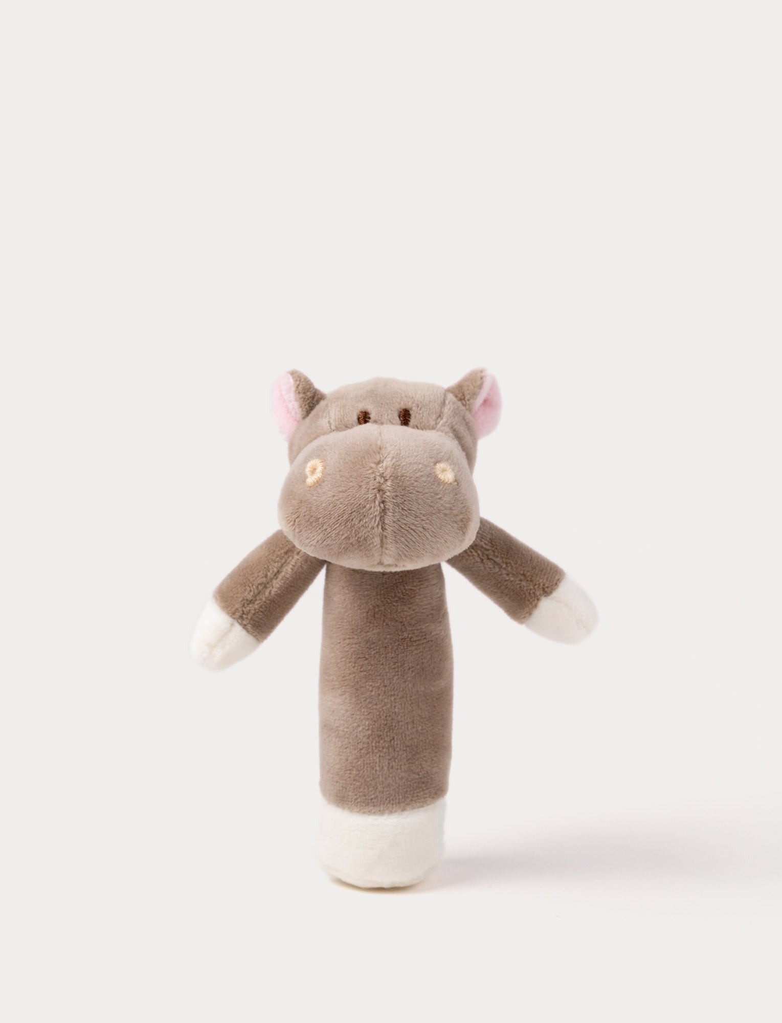 Image of Soft plush hippo rattle with a brown body, embroidered eyes, small pink ears, and white accents on the hands and base.