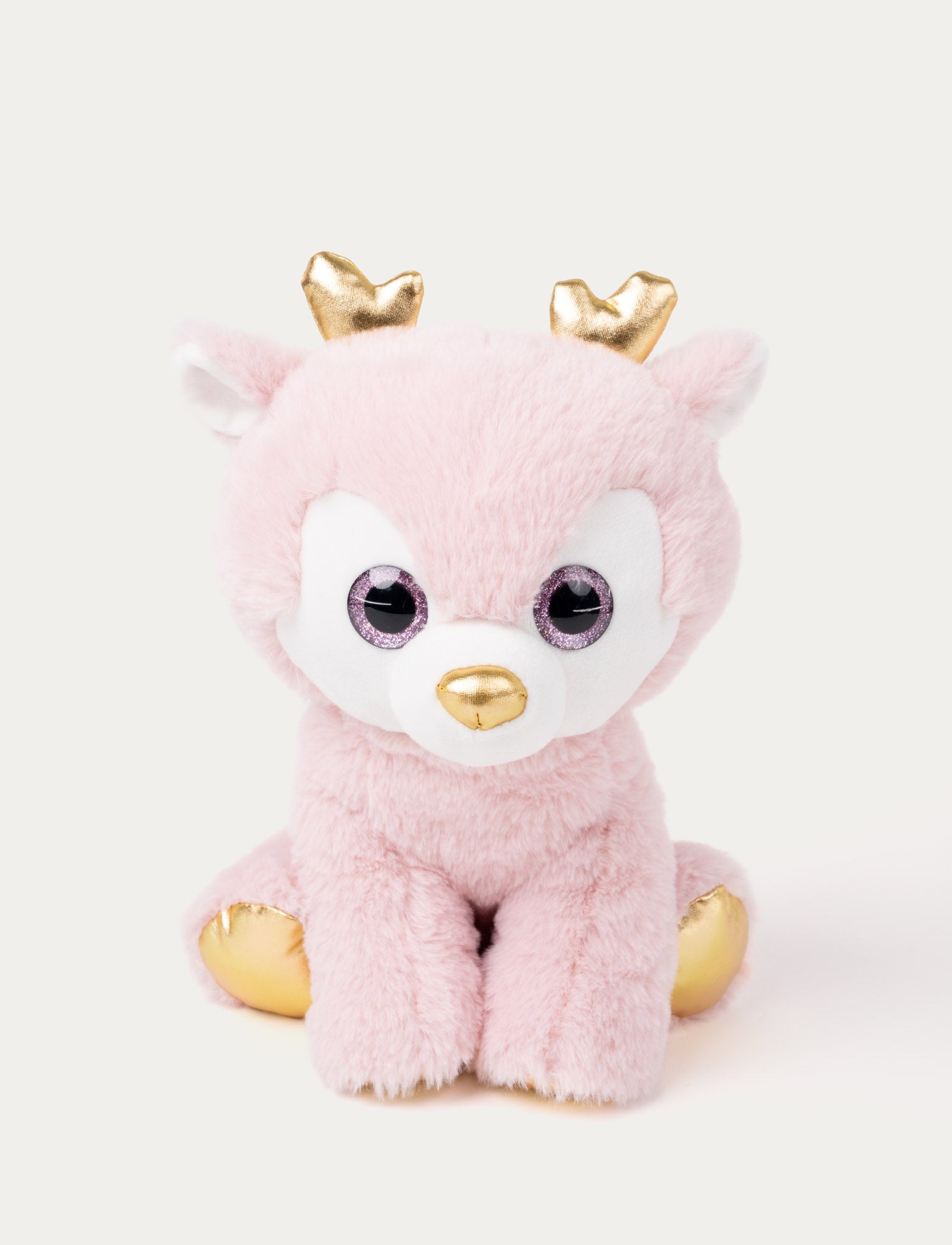 Image of A dusky pink plush deer with glittering eyes, gold details on her antlers and feet.