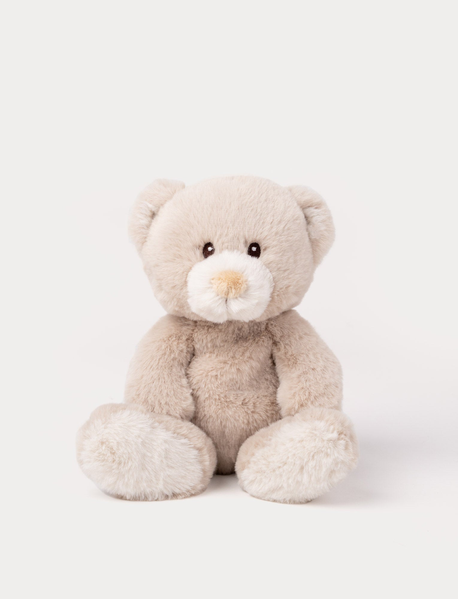 Image of A beige teddy bear with luxurious soft material, faux suede detail on its back, and embroidered eyes.