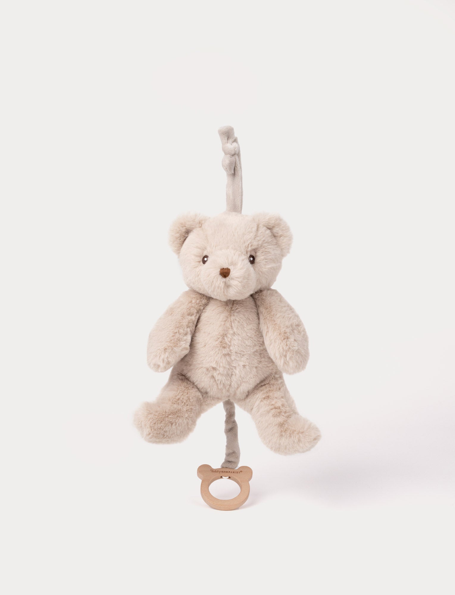 Image of Beige plush teddy bear musical toy with pull string and wooden ring.