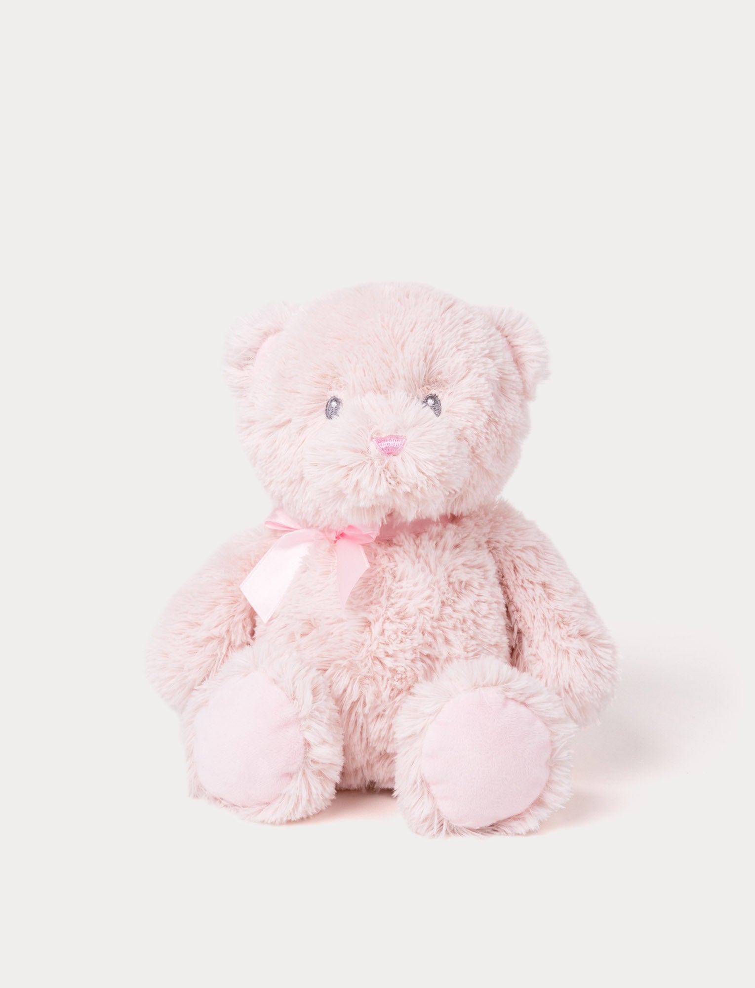 Image of Soft light pink teddy bear plush with a matching satin ribbon and embroidered facial features.