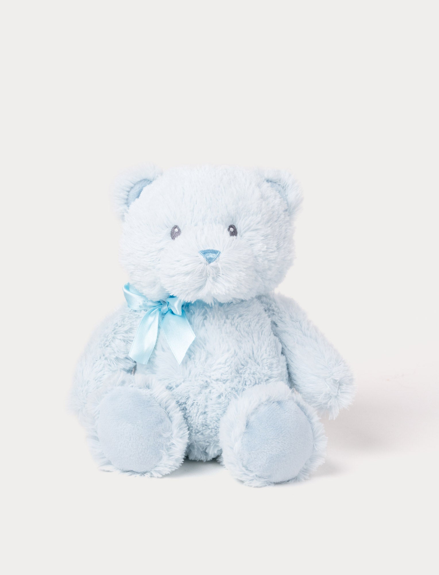 Image of Soft light blue teddy bear plush with a matching satin ribbon and embroidered facial features.