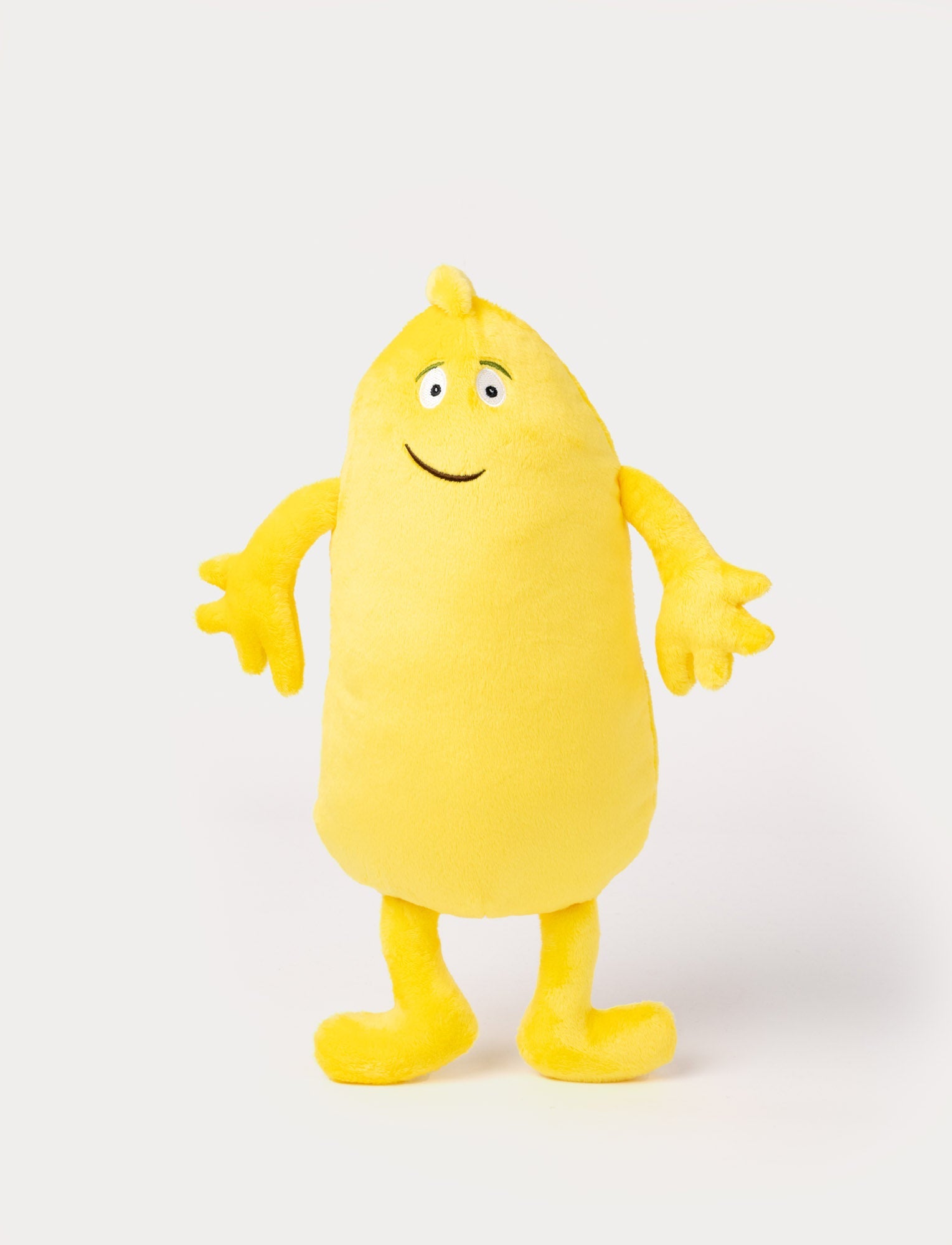  Image of Yellow plush toy with an elongated body, small tuft on top, big eyes, and a friendly embroidered smile.